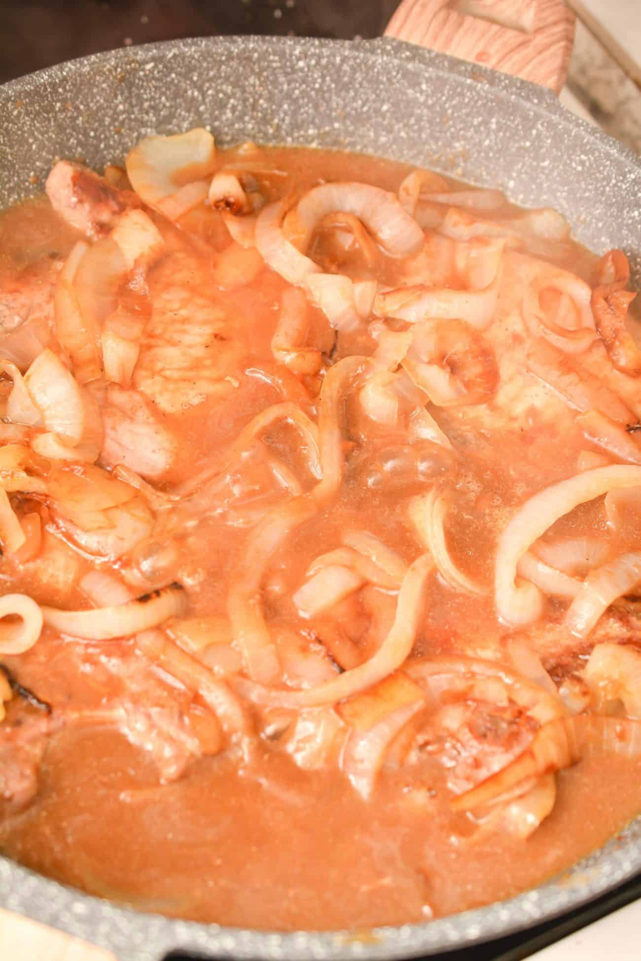 Add the pork chops and onions to the gravy in the skillet, and saute over medium-low heat covered for 15-20 minutes.