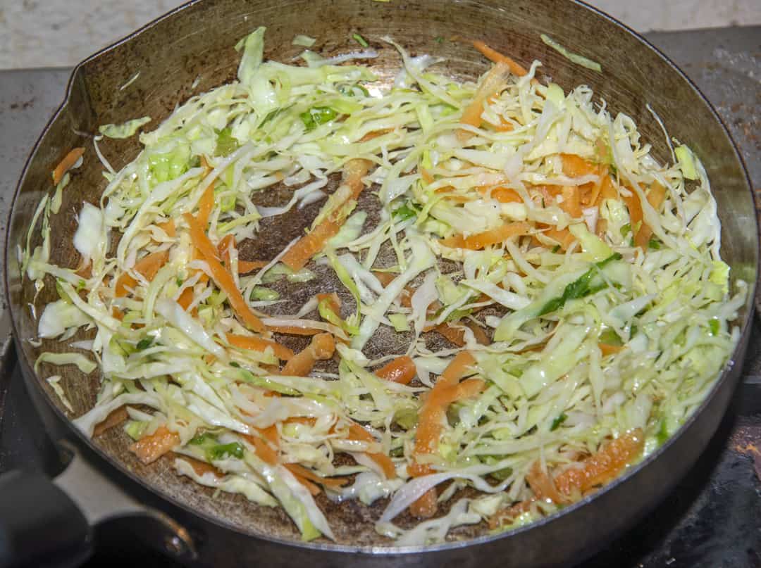 Add the seasoned Cabbage to the saucepan and cook for 3 minutes until the cabbage is softening.