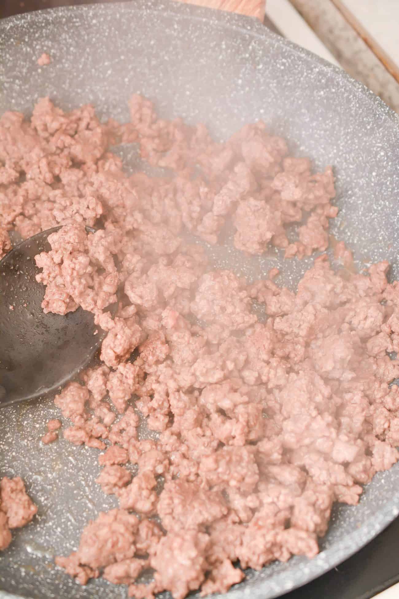 Brown the ground beef seasoned with salt, pepper, and garlic powder to taste over medium-high heat in a large deep-sided skillet until cooked through. Drain any excess grease.