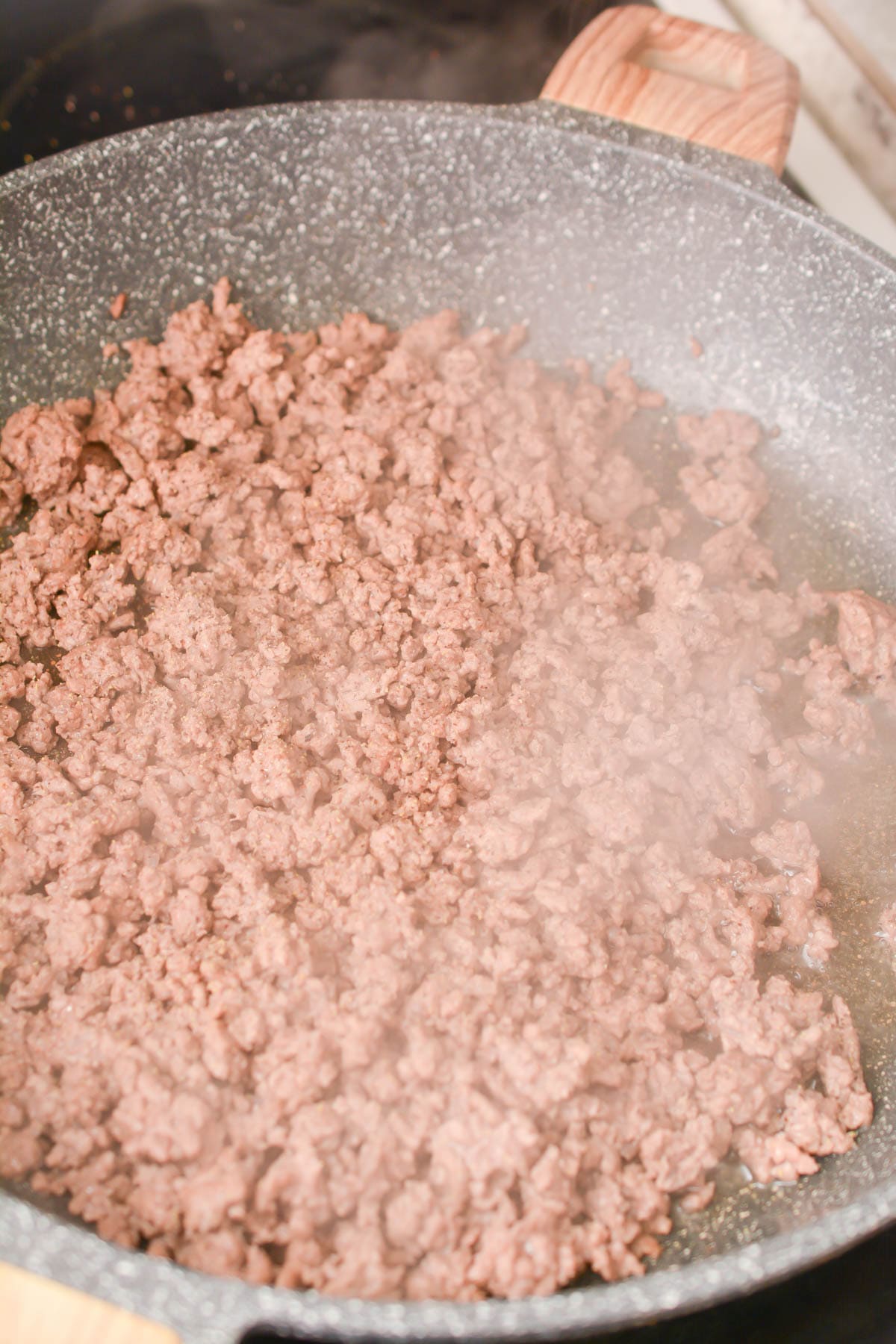Brown the ground beef in a skillet over medium-high heat on the stove. Drain any excess fat, and reduce the heat to medium-low.