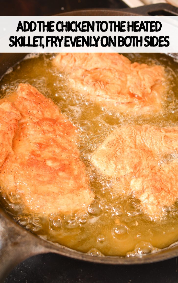 frying chicken in a iron skillet pan