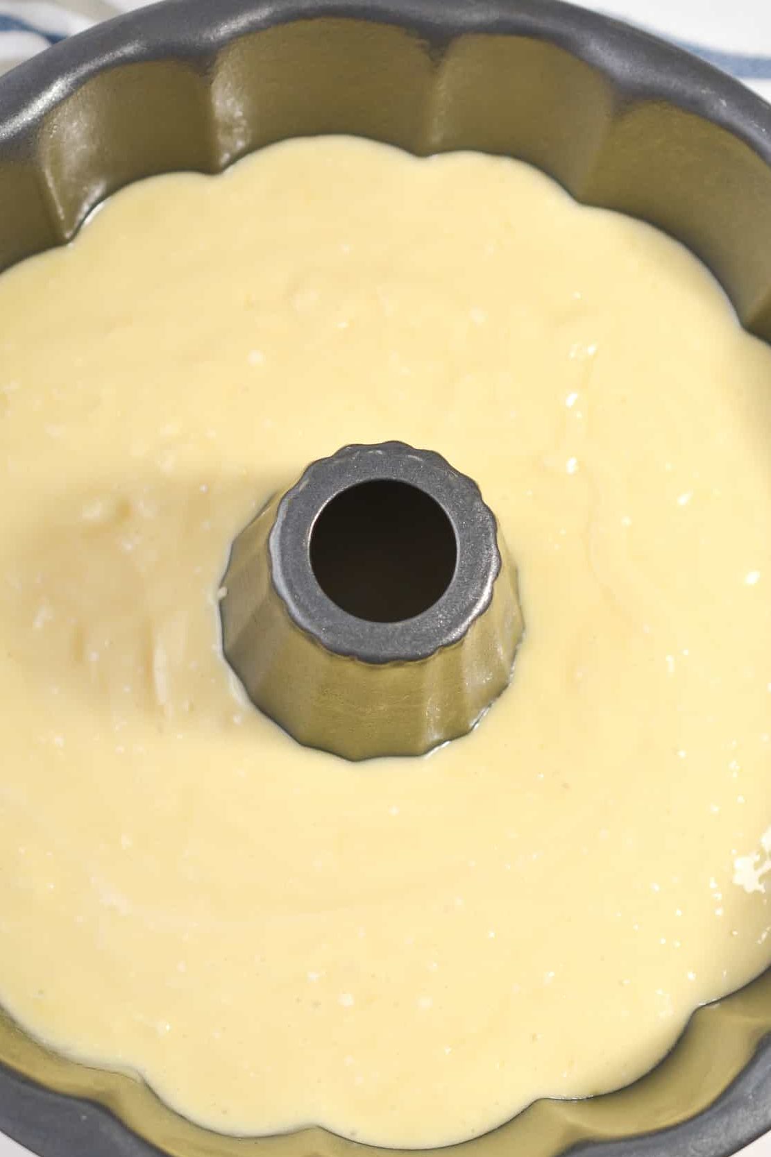 Pour the batter into a well-greased bundt pan.