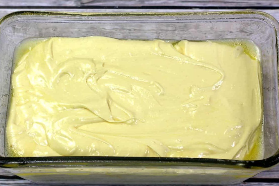Pour the pound cake batter into a greased baking pan.