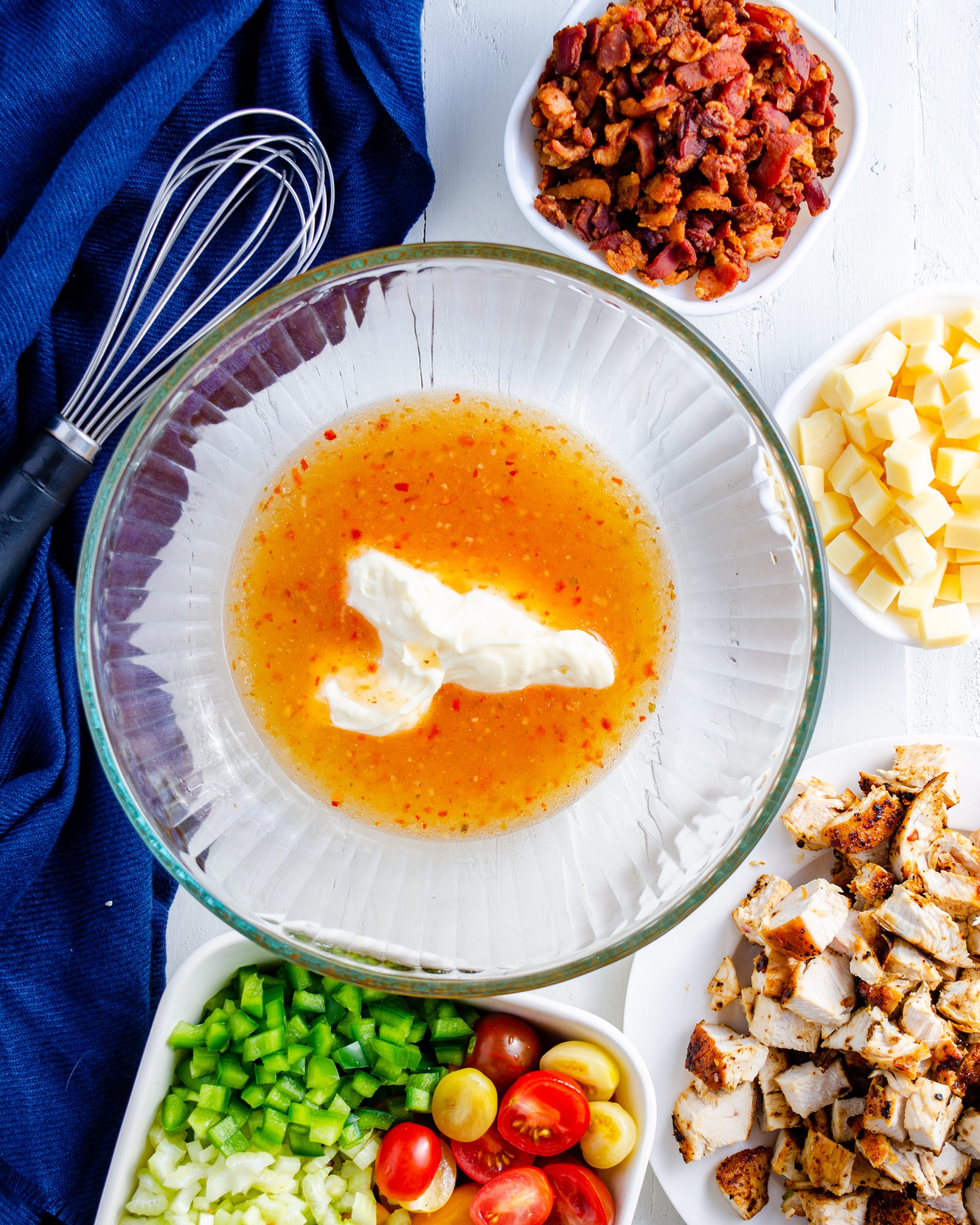Whisk Italian-style dressing and mayonnaise together in a large bowl.