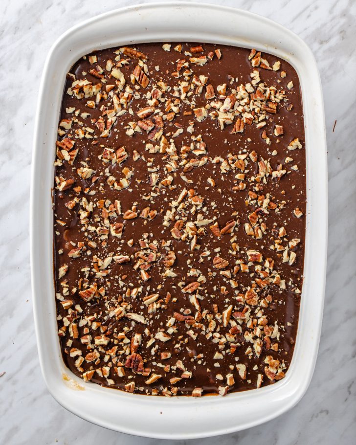 Sprinkle toasted pecans on top of the cake and let it cool to room temperature. 