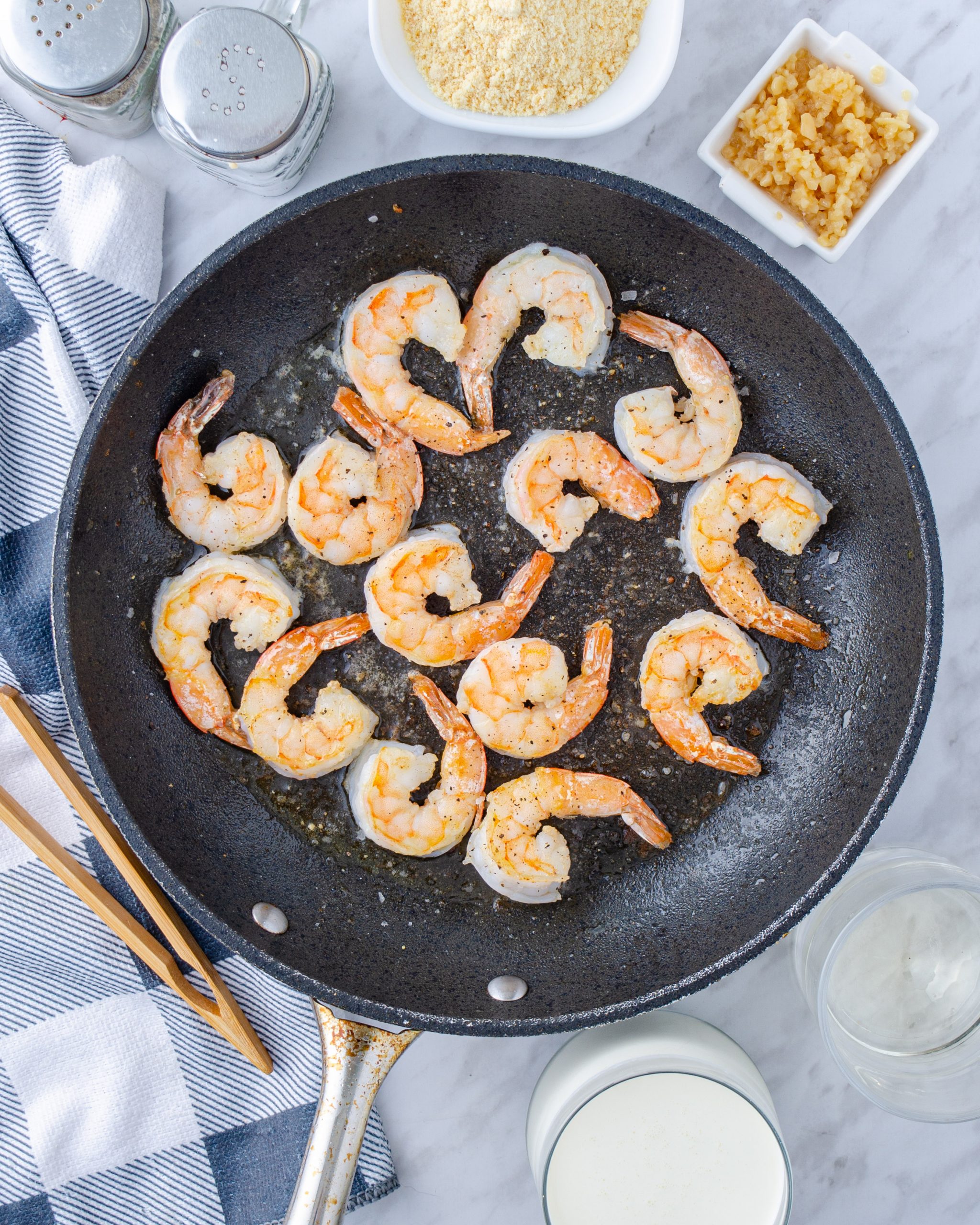 Add the shrimp to the skillet and season with salt and pepper to taste. Saute on both sides until seared and cooked through. Remove and set aside.
