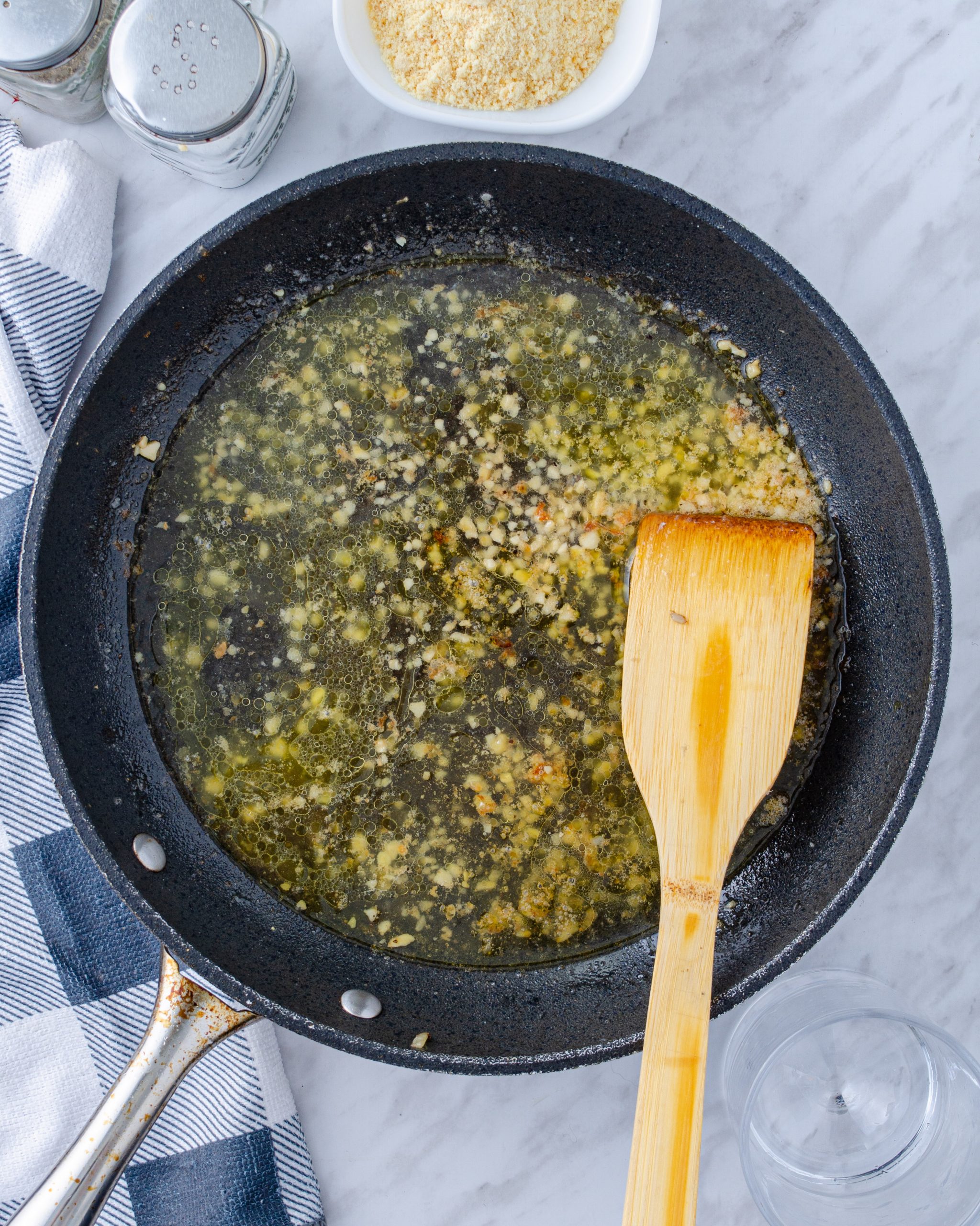 Stir the white cooking wine into the skillet, and simmer until the liquid is reduced by half.