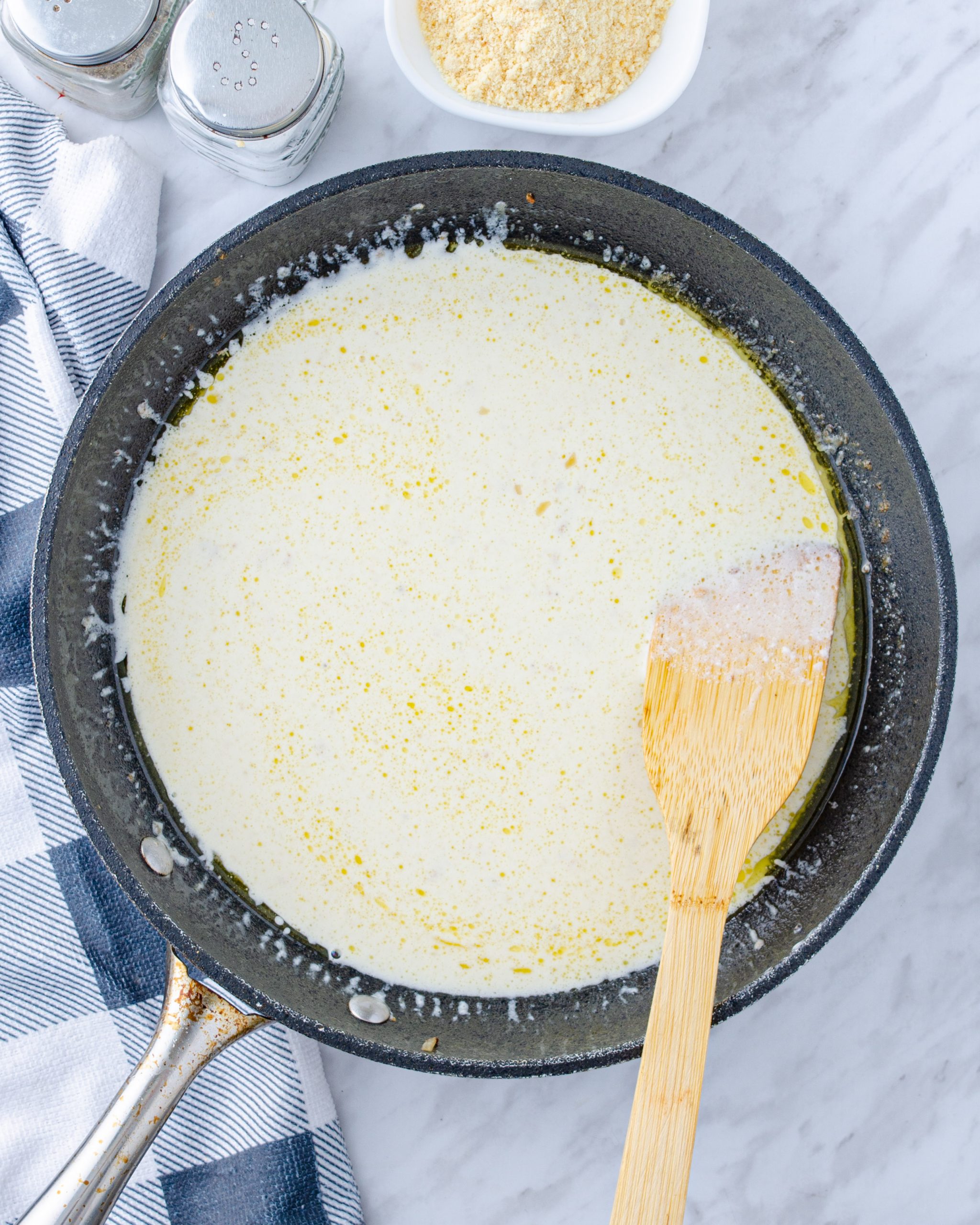 Whisk the heavy whipping cream into the skillet and simmer until the sauce has thickened.