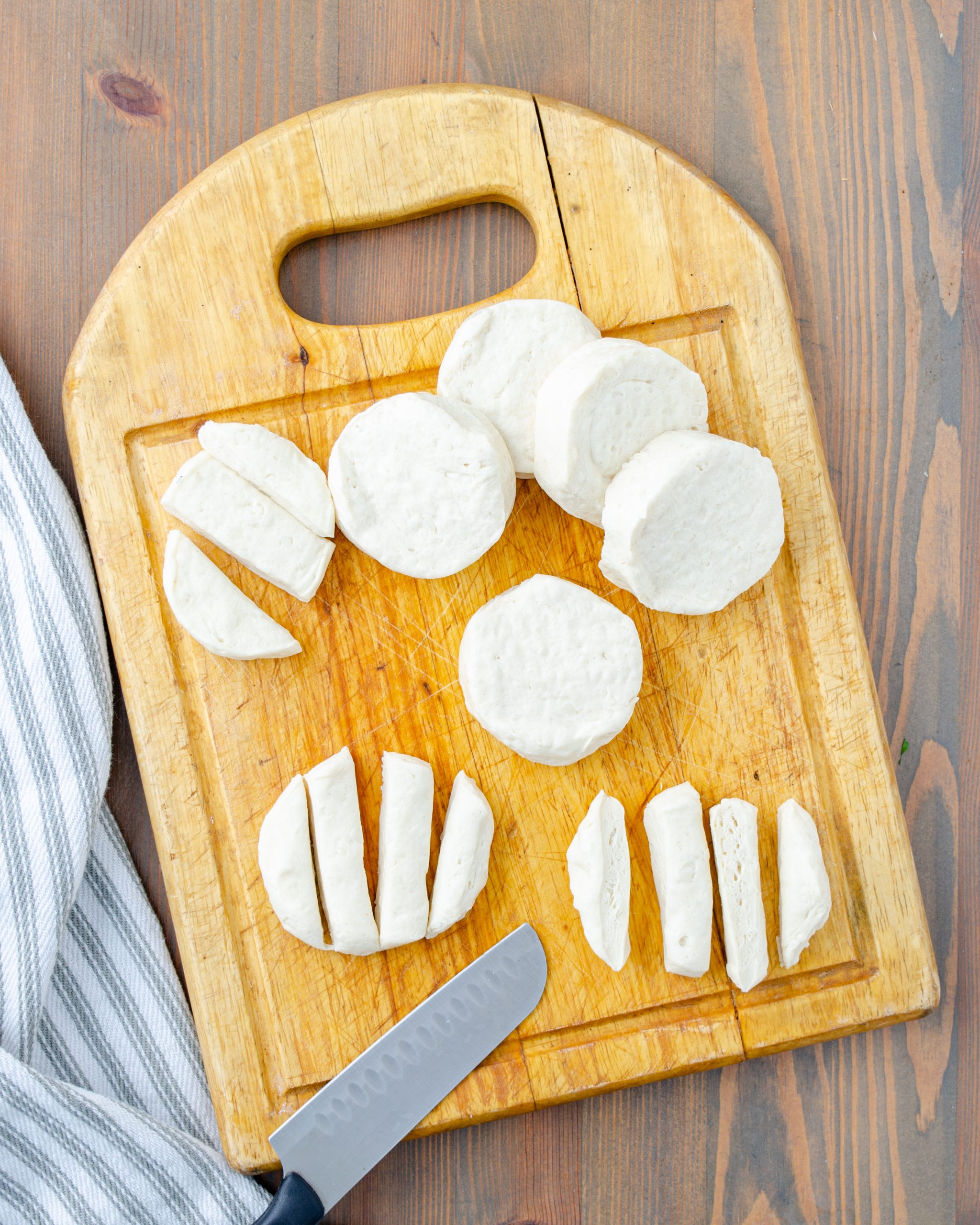 Flatten biscuits and cut each one into 4 long pieces.