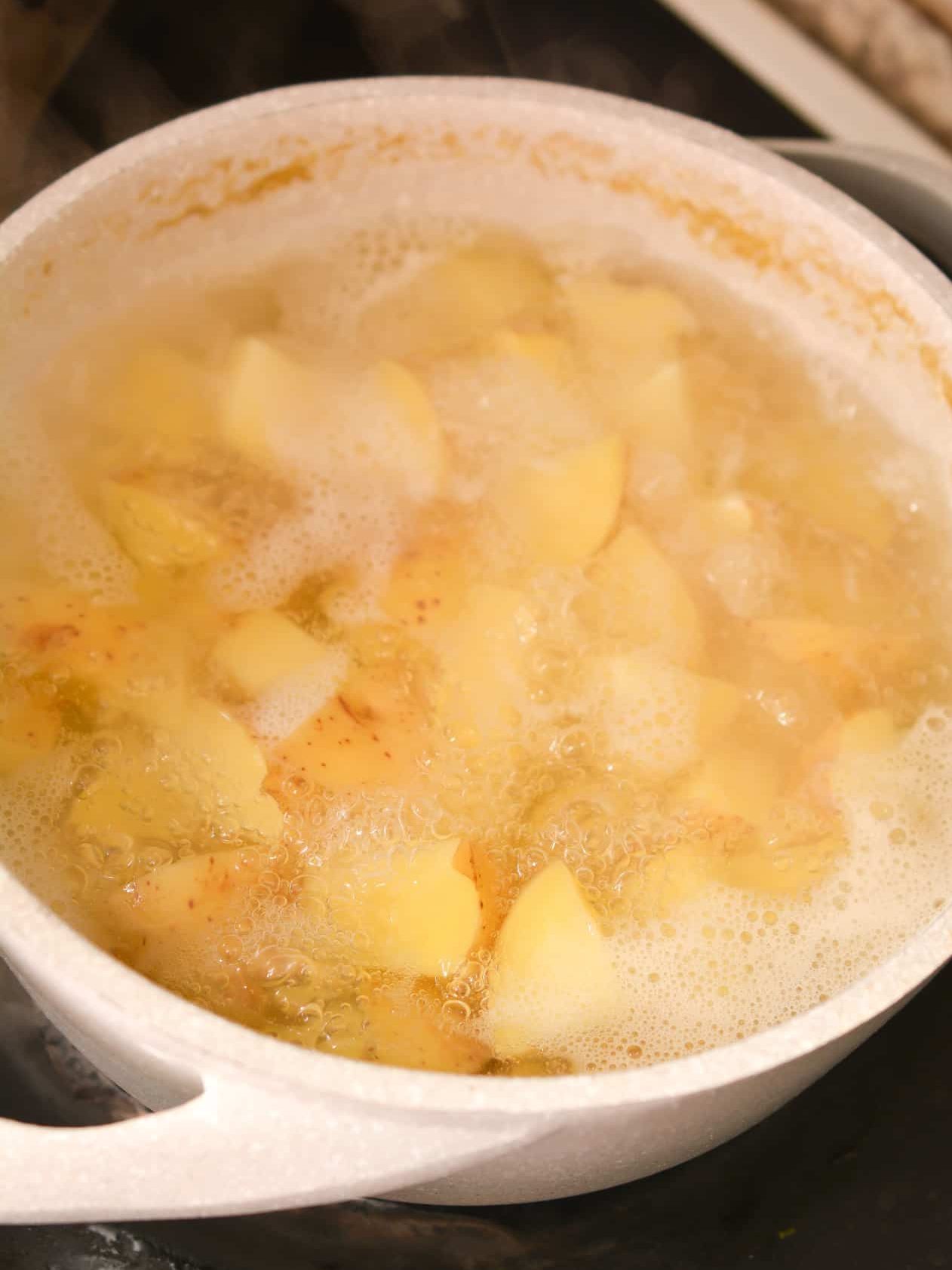 Start by boiling the potatoes