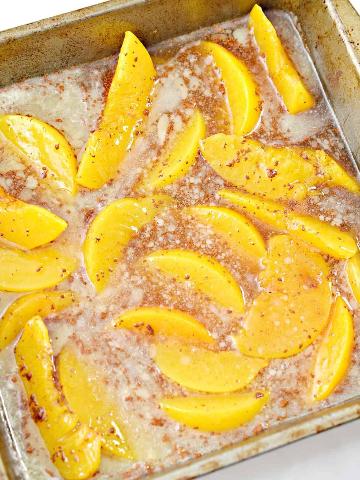 Place the peach mixture into the baking dish and cover with the cake crumbles, ¼ cup of sliced cold butter, and pecans. Bake for 25-30 minutes and let cool.