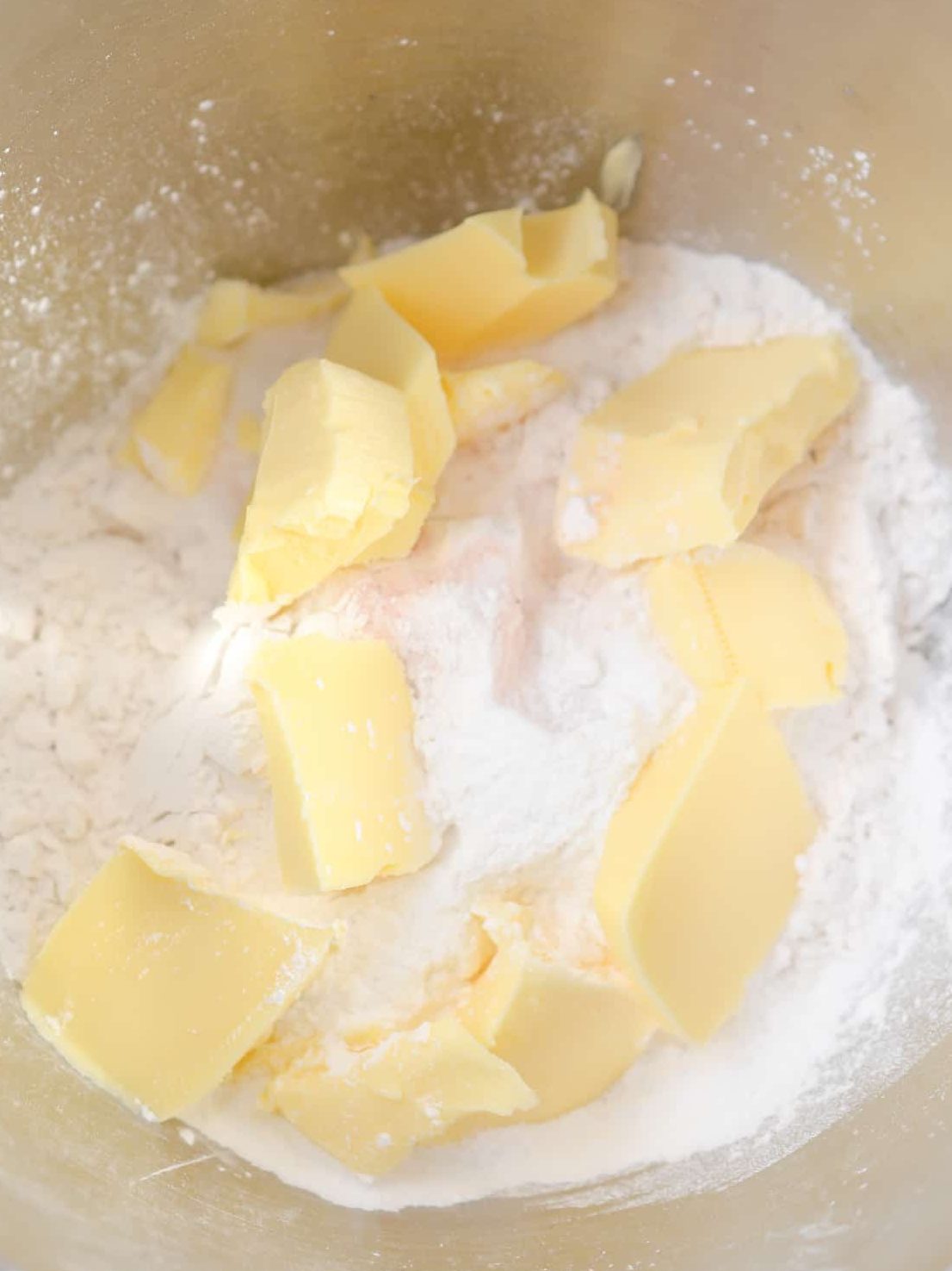 Add the shortenings to the bowl, and cut into the dry ingredients with the tines of a fork until a crumbly dough forms.