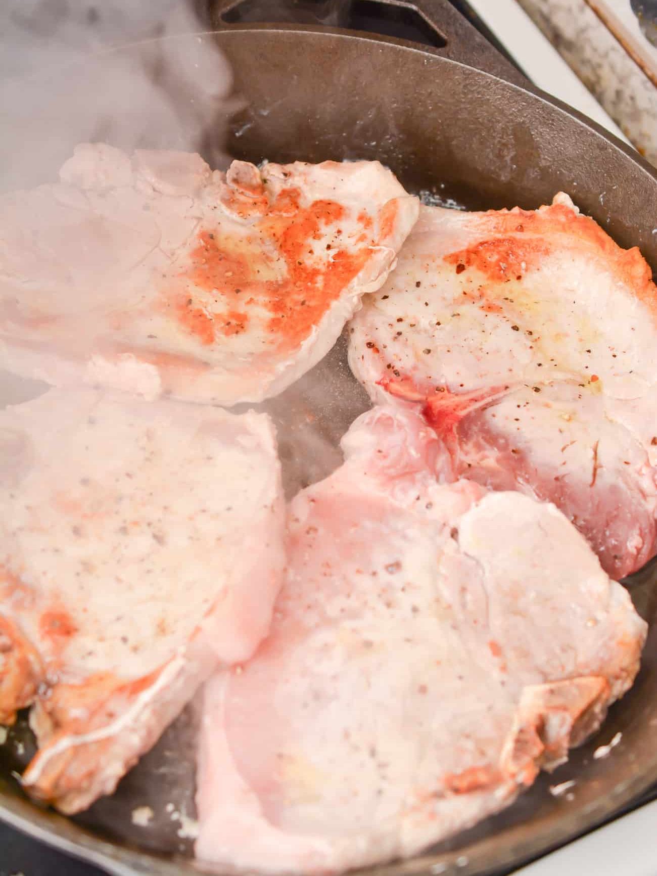 Heat the oil in a skillet over medium-high heat and sear both sides of the pork chops. Remove and set aside.