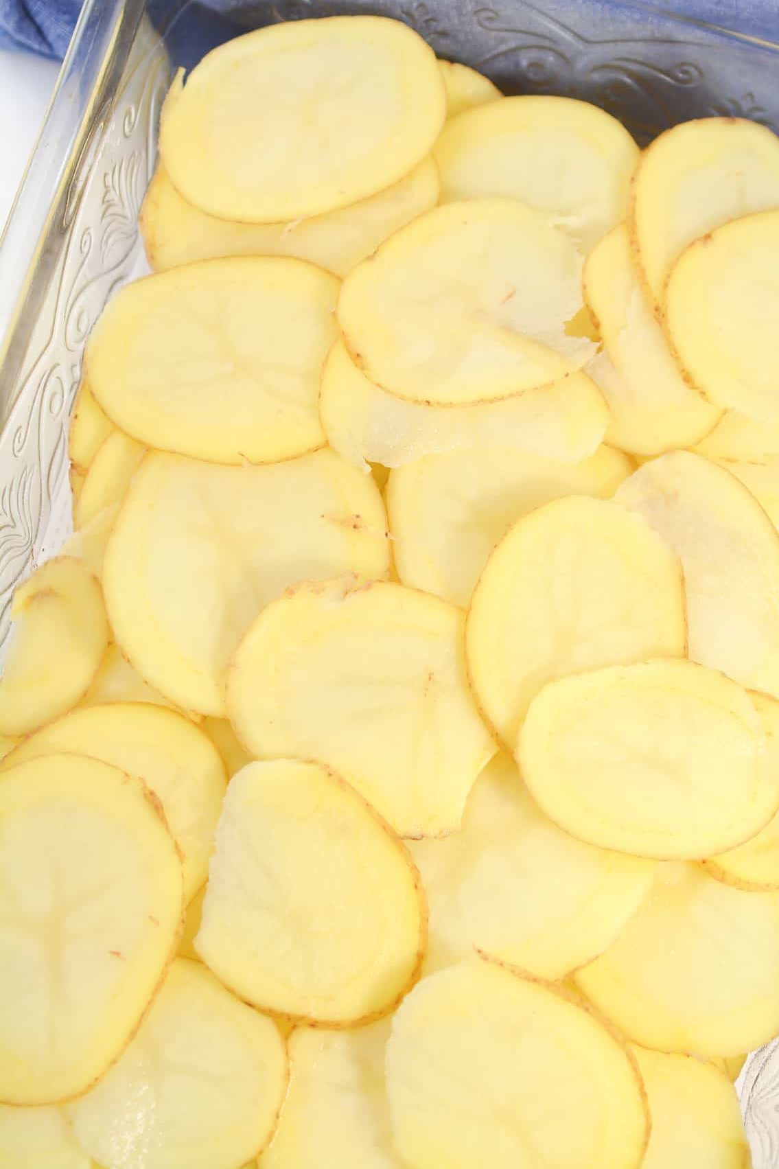 Layer the potatoes on the bottom of a well-greased 9x13 baking dish.