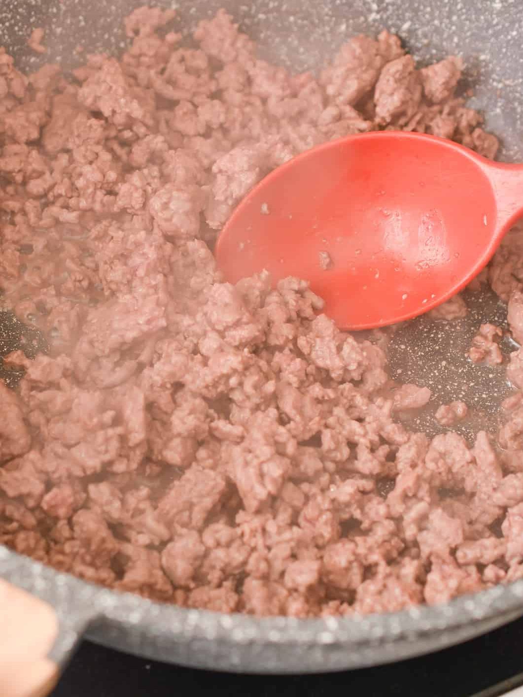 Add the 1 lb of ground beef to a skillet over medium-high heat and cook until browned completely.