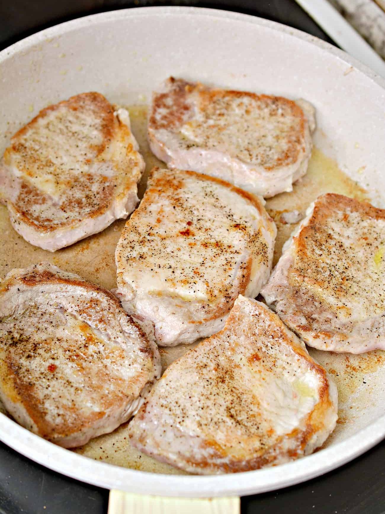 Add the pork chops to the heated skillet and brown on both sides. Remove, and set aside.