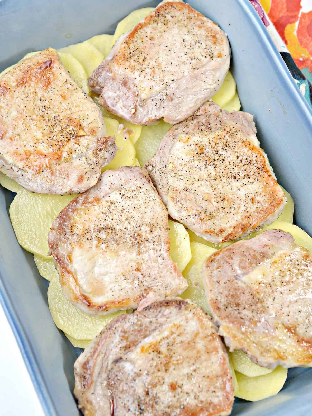 Place the browned pork chops on top of the potatoes.