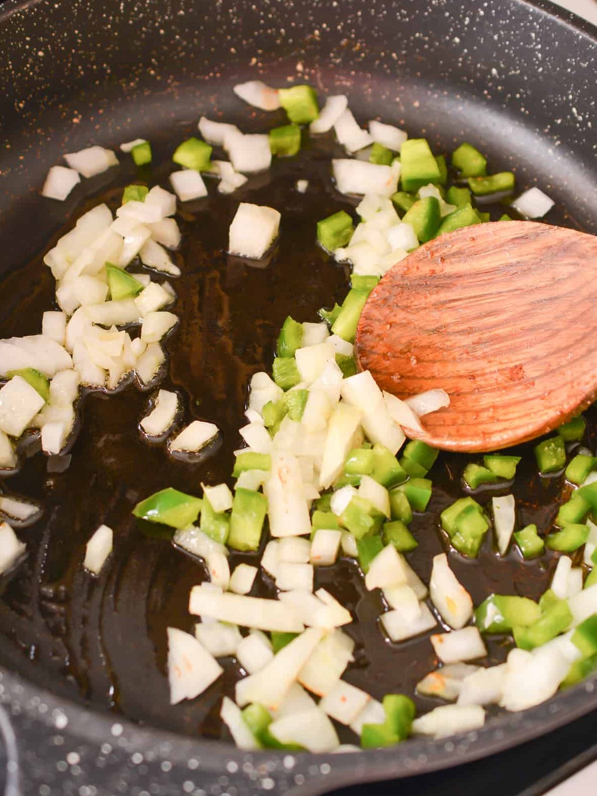 Saute the onions and peppers over medium heat until softened.