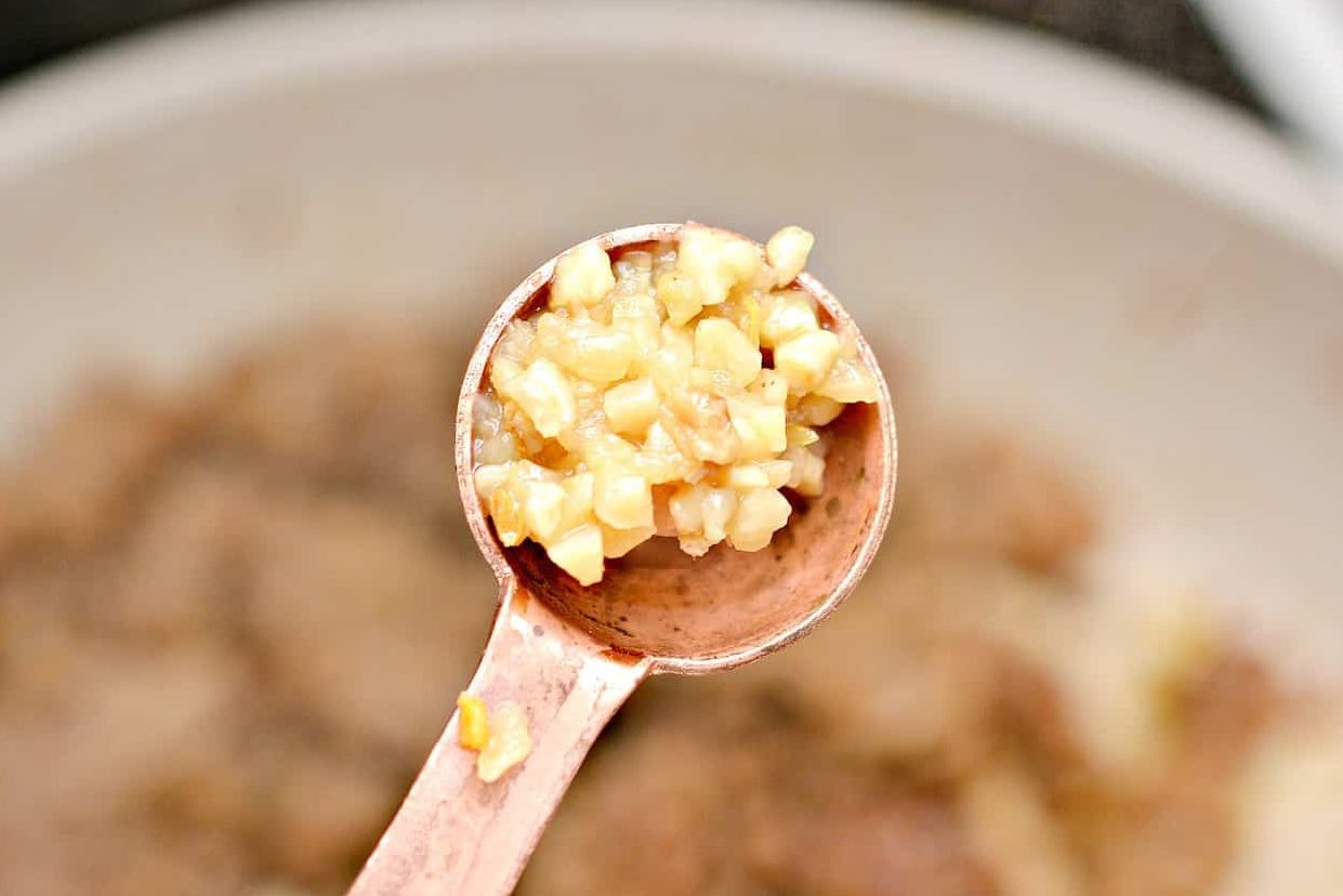 Add the minced garlic to the skillet with the meat and saute an additional 30 seconds. Drain any excess fat.