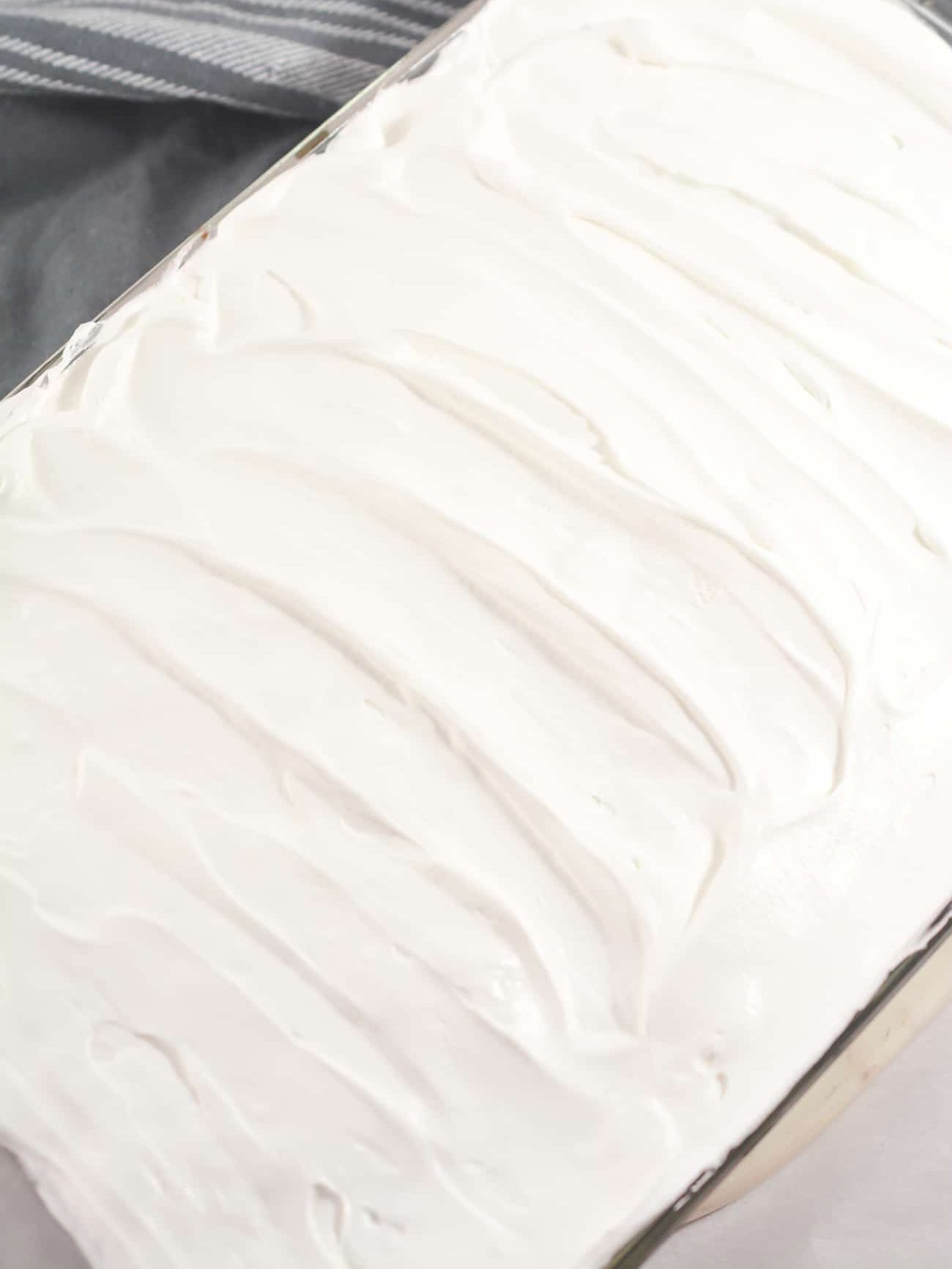 Top the cake with the Cool Whip and serve.