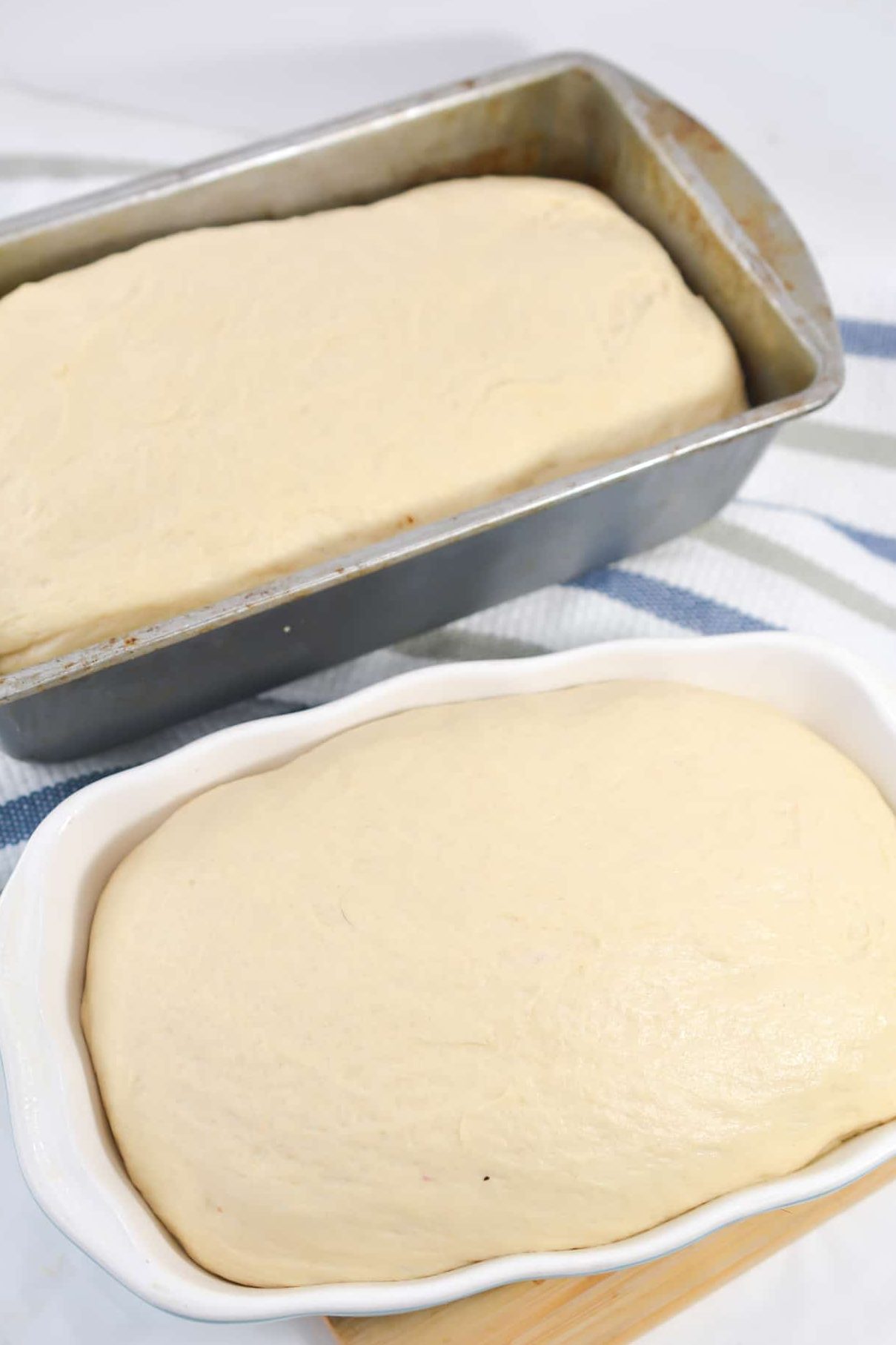 Place the dough into a large bowl that has been coated in cooking spray, cover with a damp cloth