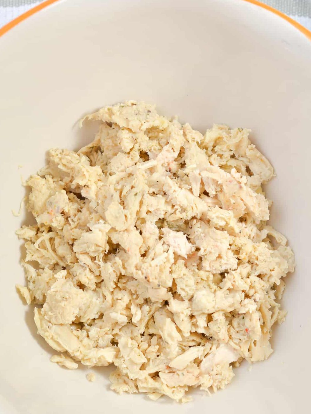 I added 1 cup of Shredded chicken to a mixing bowl.