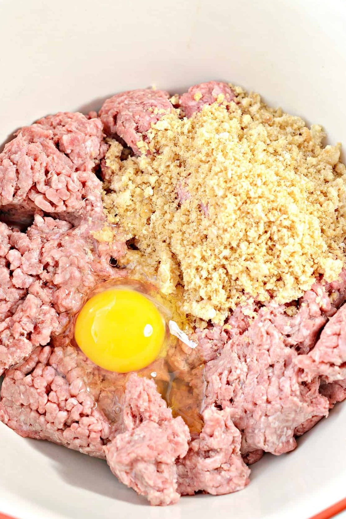 In a mixing bowl, combine the ground beef, bread crumbs, and eggs.