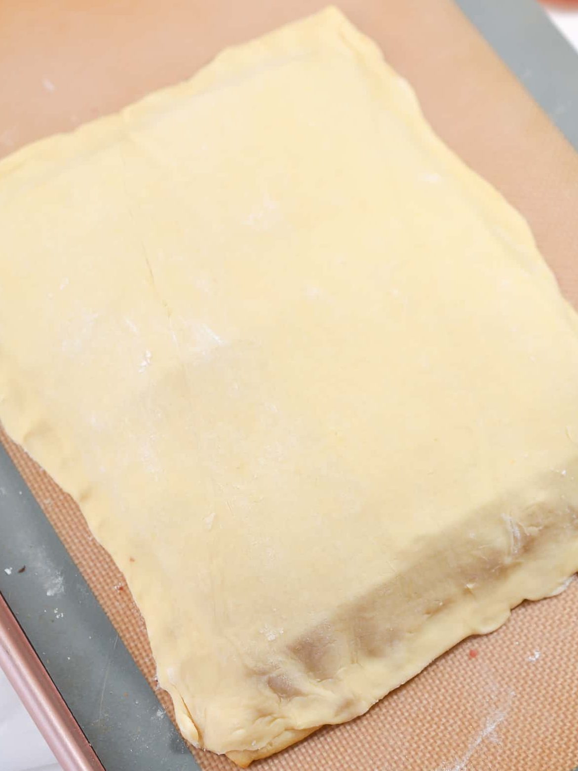 Roll out the other half of the dough, and spread it over the mixture, pinching the edges closed around the bottom.