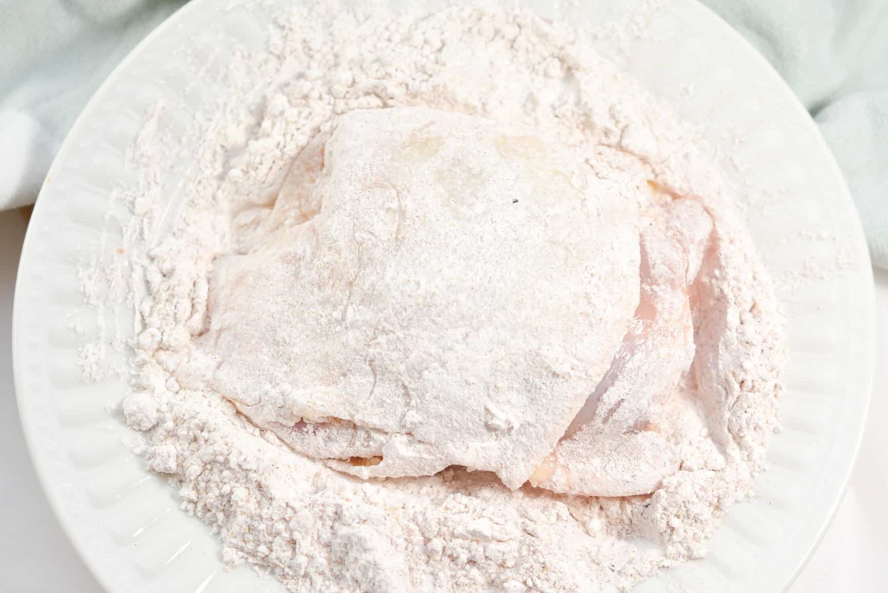 Dredge the chicken well in the flour mixture 