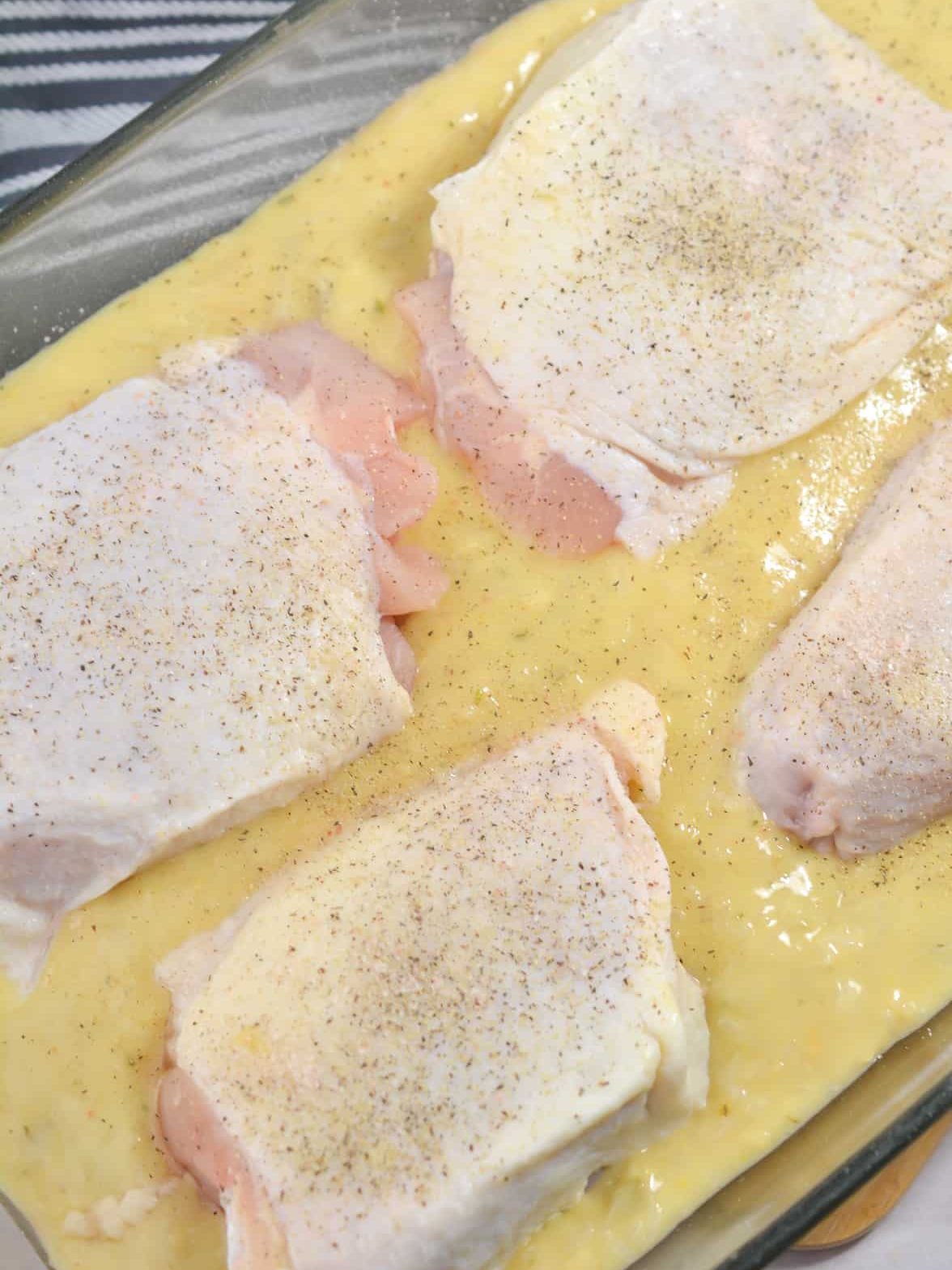 Season the chicken with salt and pepper and place on top of the rice mixture in the dish.