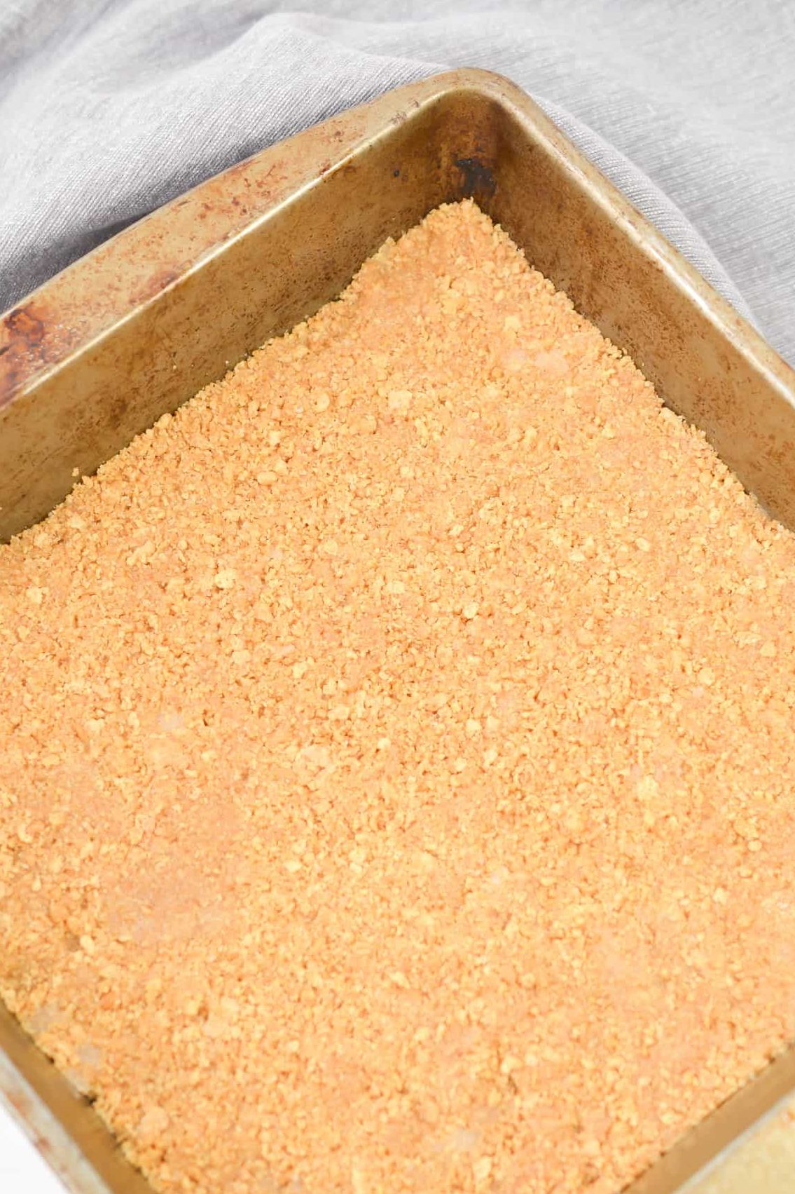 Press the crust mixture into the bottom of a well-greased 9x9 baking dish.
