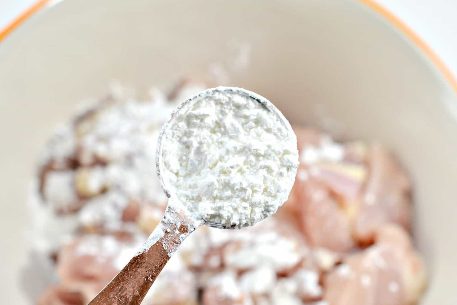 Add the chicken pieces to a mixing bowl with the cornstarch.