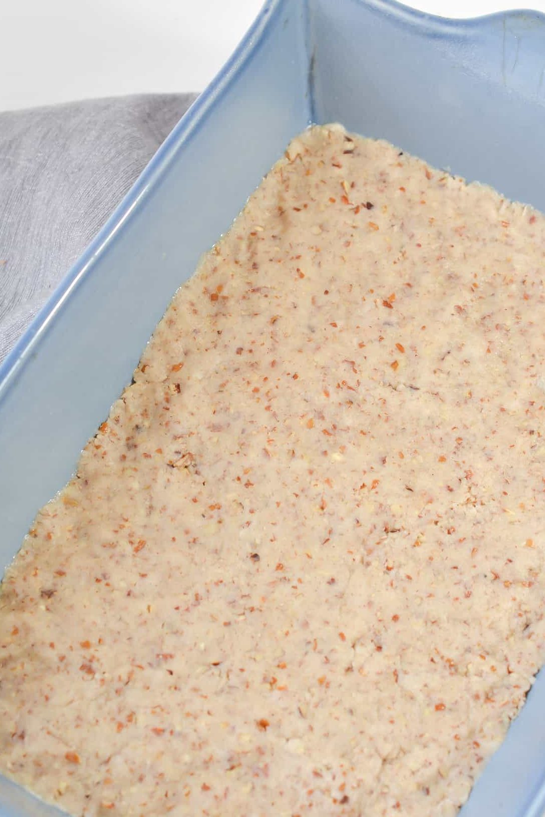 Press the mixture into the bottom of a well-greased 9x13 baking dish