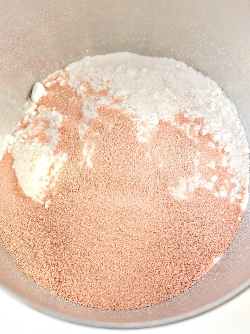 Mix together the white cake mix and box of strawberry Jello in a mixing bowl.
