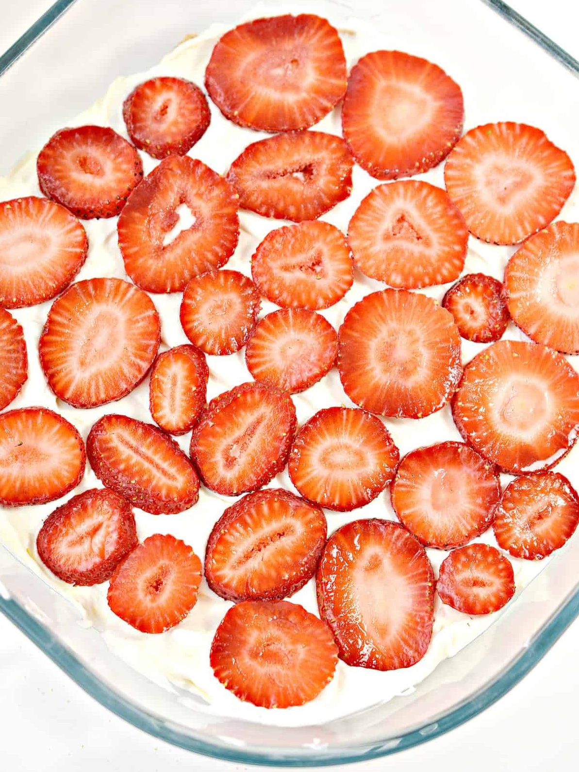 Place a layer of sliced strawberries along the top of the cream cheese mixture.