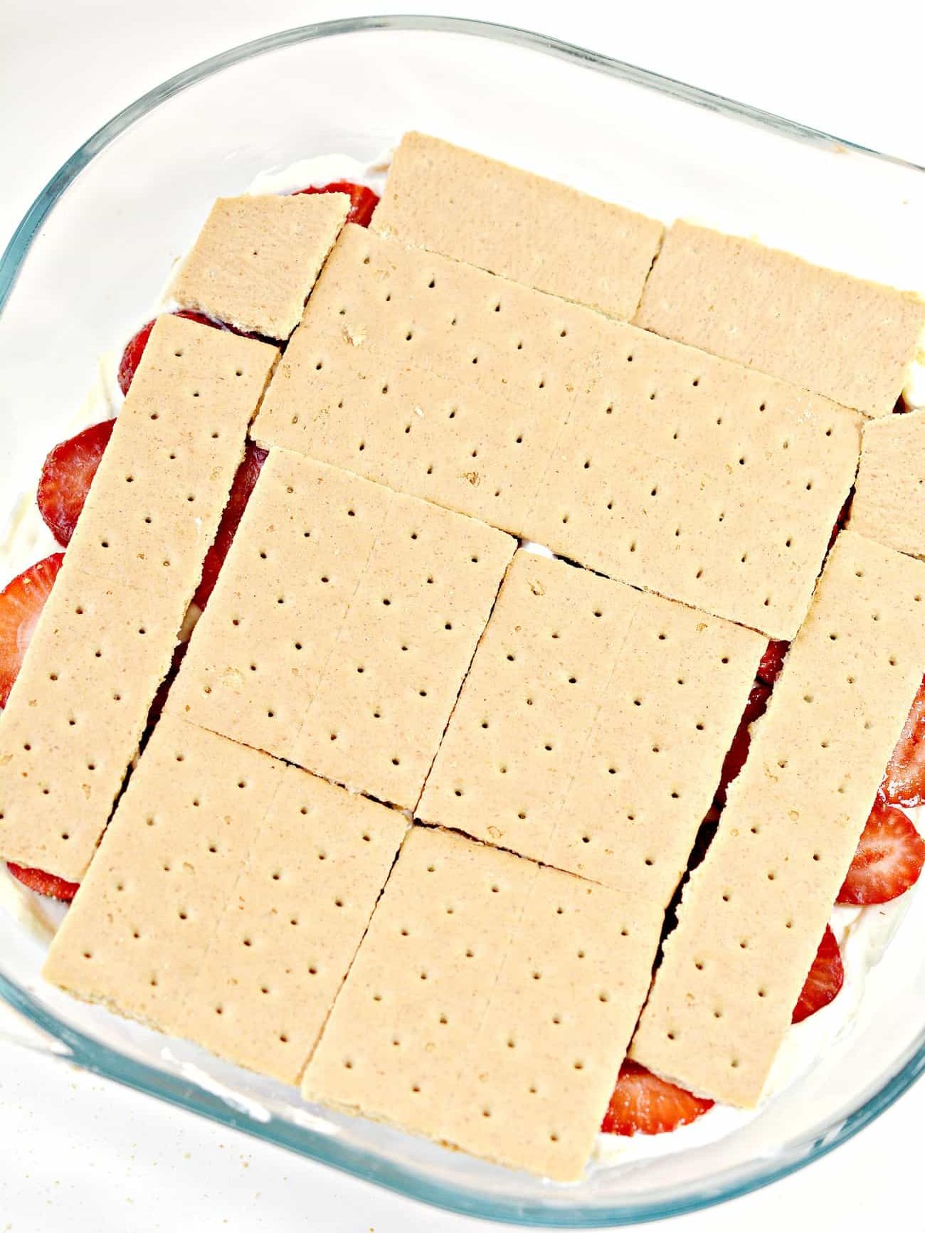 Put another layer of graham crackers on top of the strawberries.