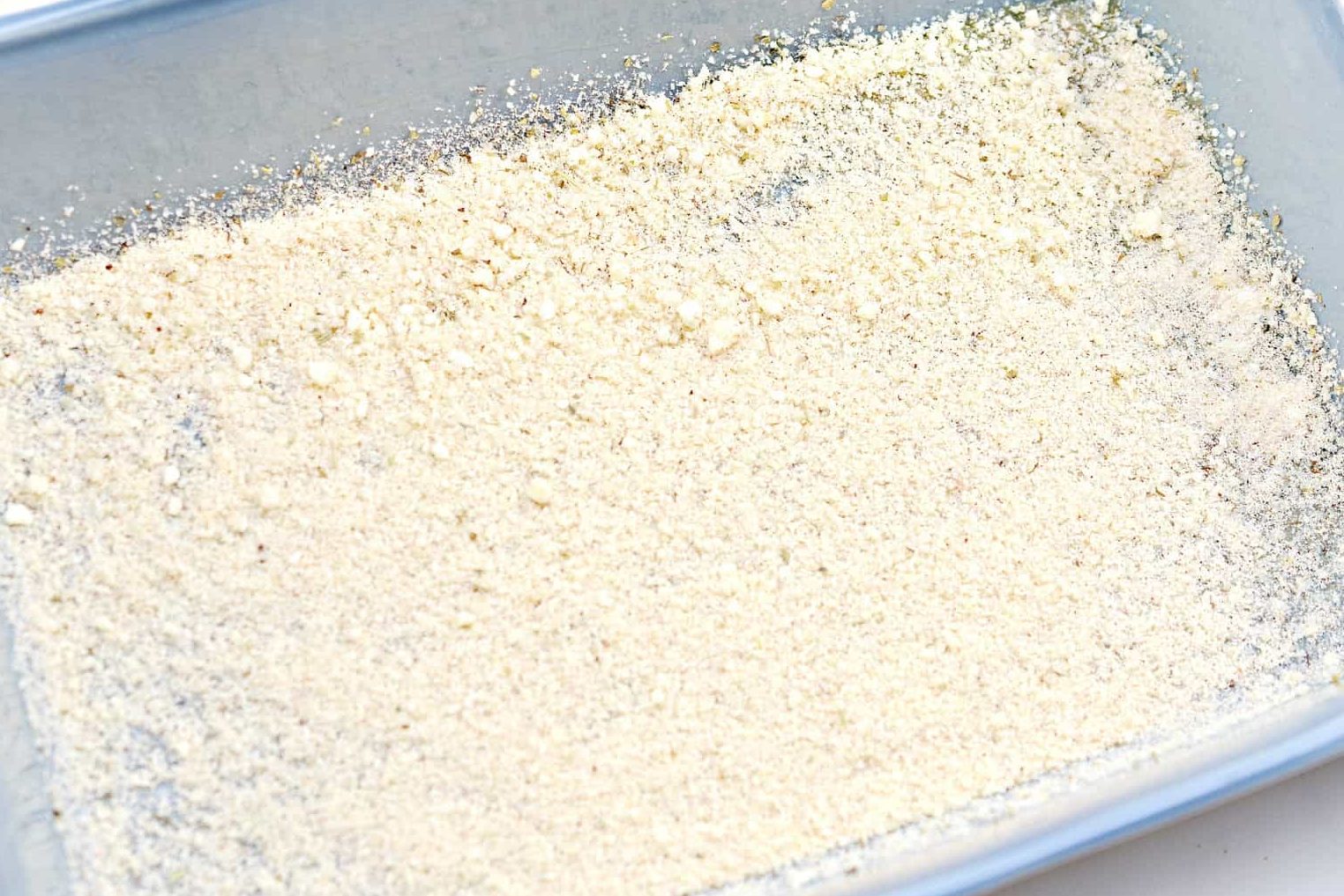Layer the parmesan mixture into the bottom of the baking dish in an even layer.