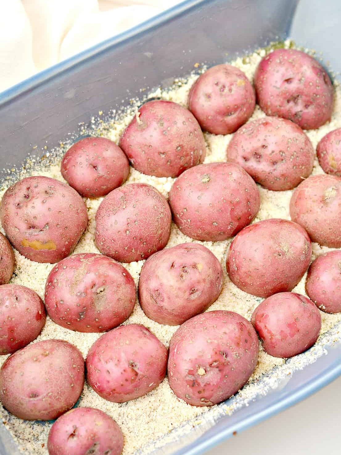 Press the potatoes cut side down into the parmesan mixture.