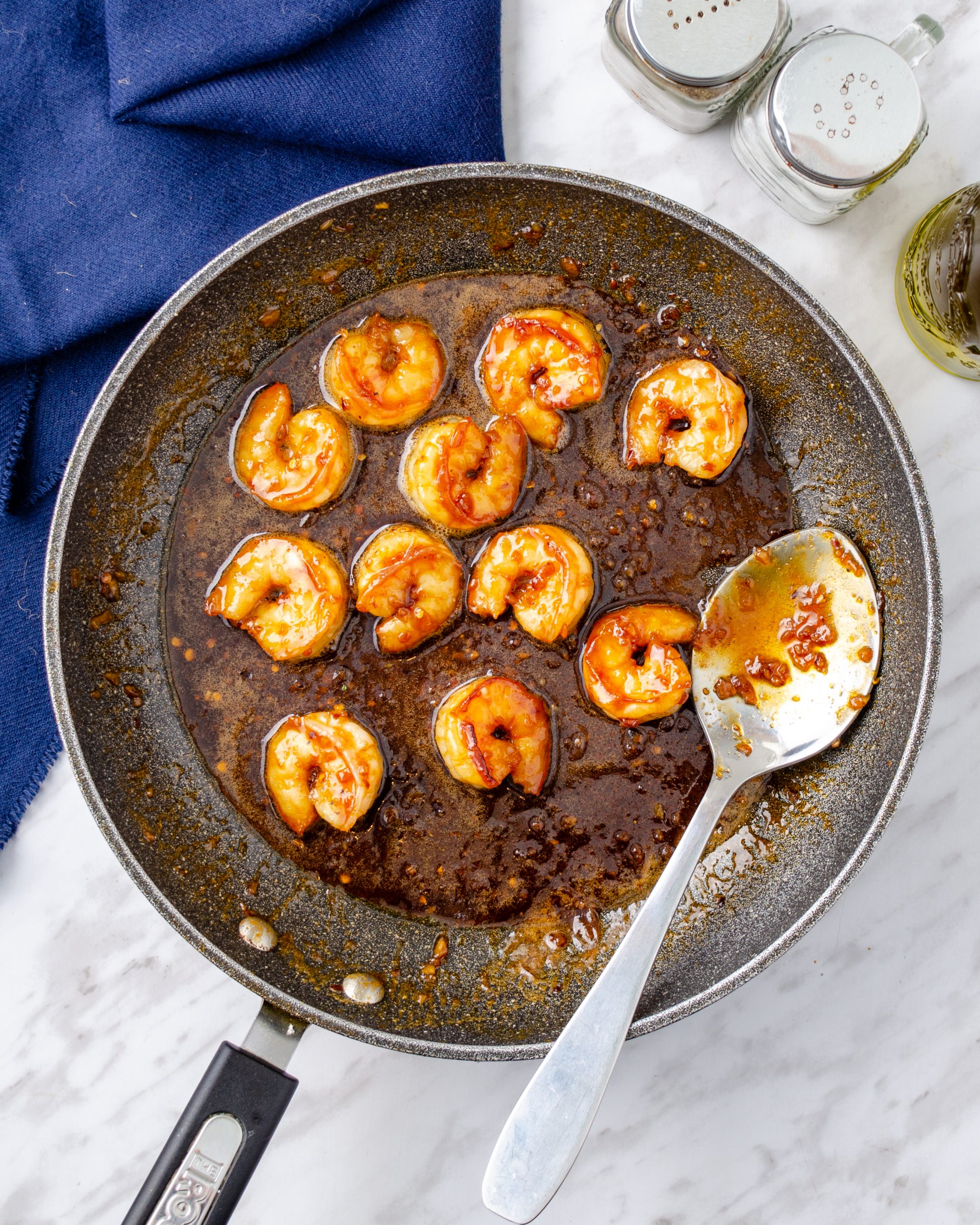 Pour the sauce over the shrimp, reduce the heat on the stove to medium and saute until the sauce thickens and becomes a bit sticky.