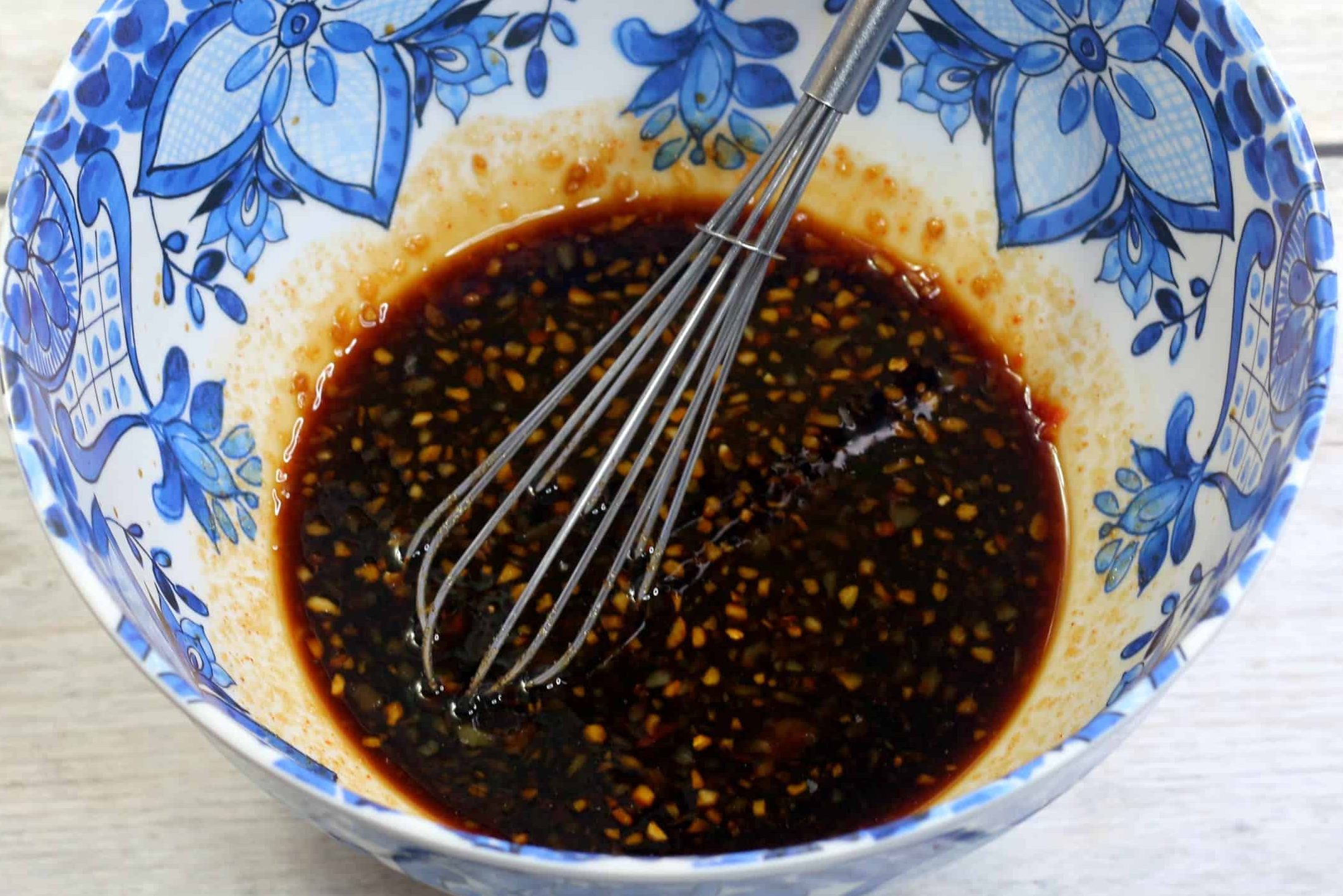 Prepare the marinade by whisking the brown sugar, ground ginger, garlic, soy sauce, and sambal paste in a bowl. 