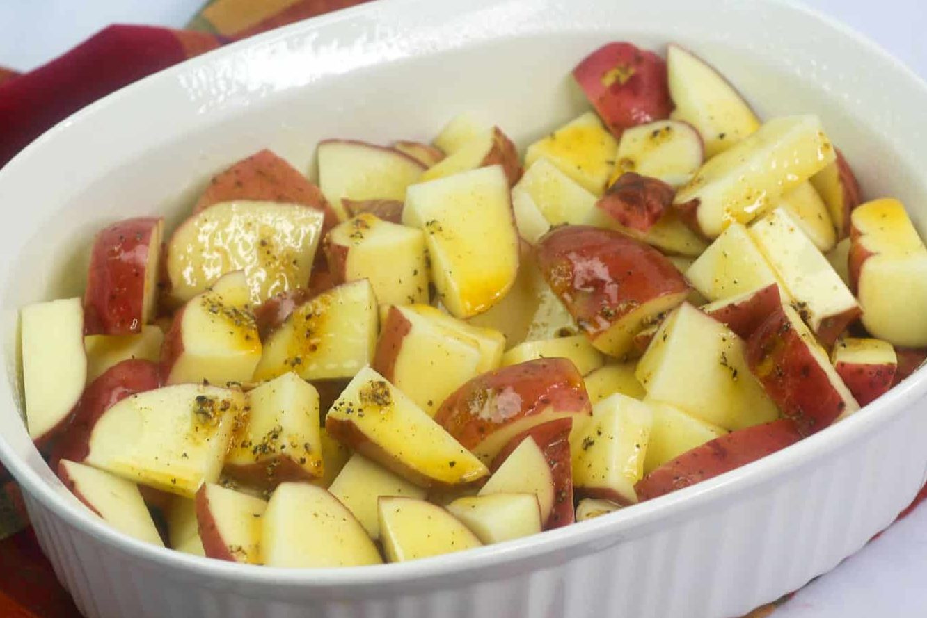 In a medium bowl, mix the melted butter, paprika, salt, pepper, and garlic powder together. Once mixed, pour over the potatoes. 