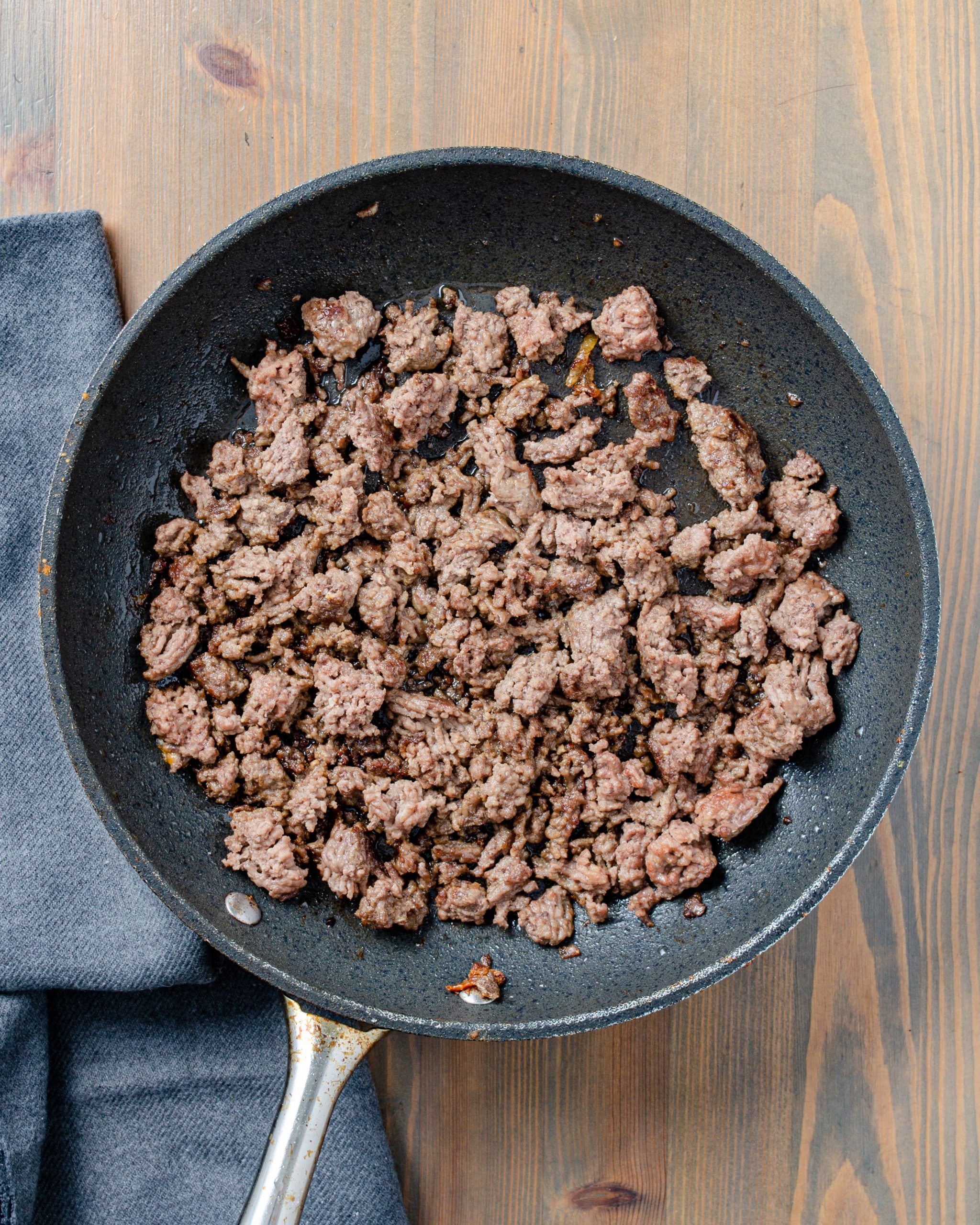Add the ground beef to a skillet over medium-high heat on the stove and cook until browned completely. Drain any excess fat.