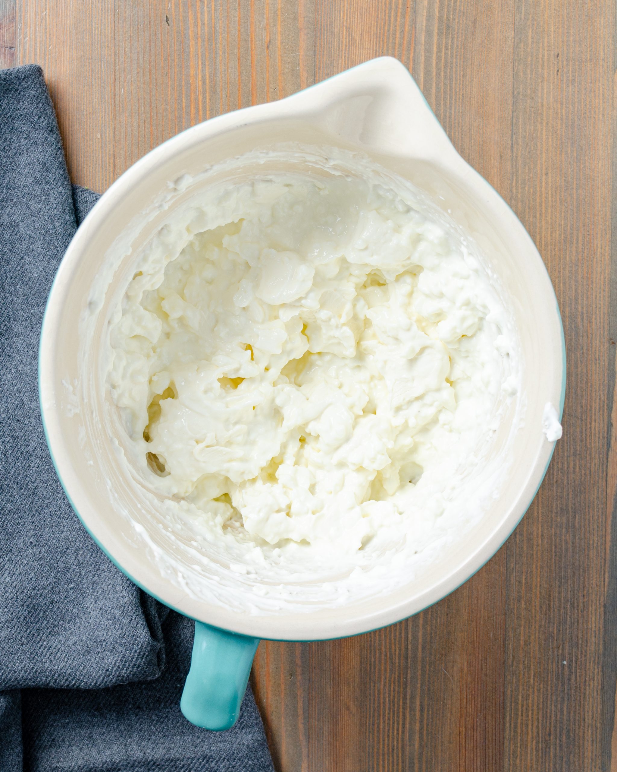 In a bowl, stir together the cream cheese, cottage cheese, and sour cream until well combined.