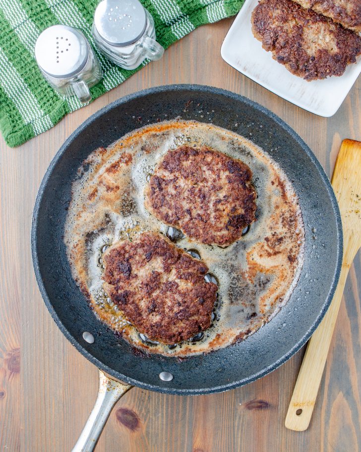 In a large pan add the oil, and heat over medium-high heat, when the oil is hot, add the beef patties to the skillet, cook for 2-3 minutes on each side until browned.