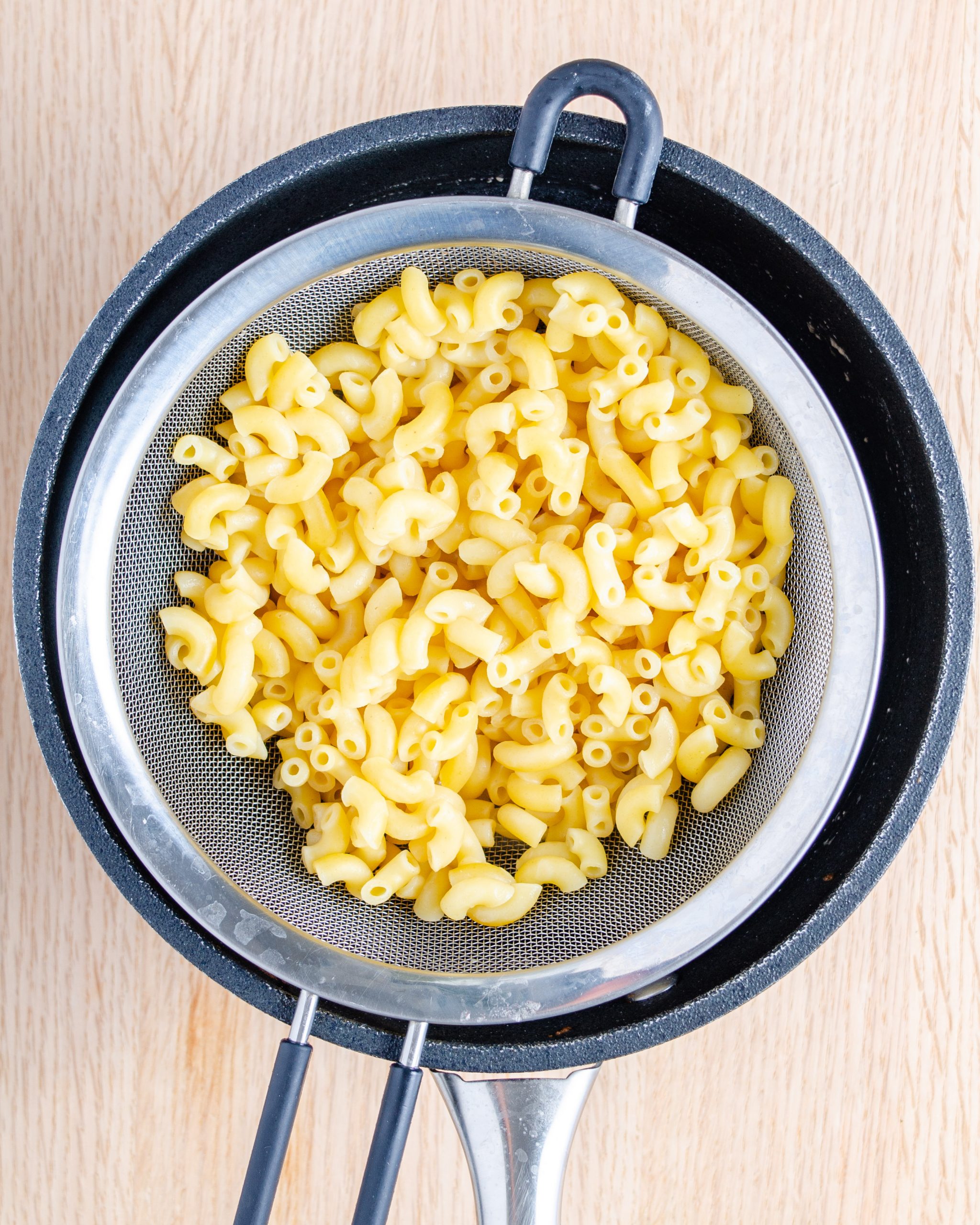 Boil the macaroni until it is done to your liking, rinse in cold water, and drain.