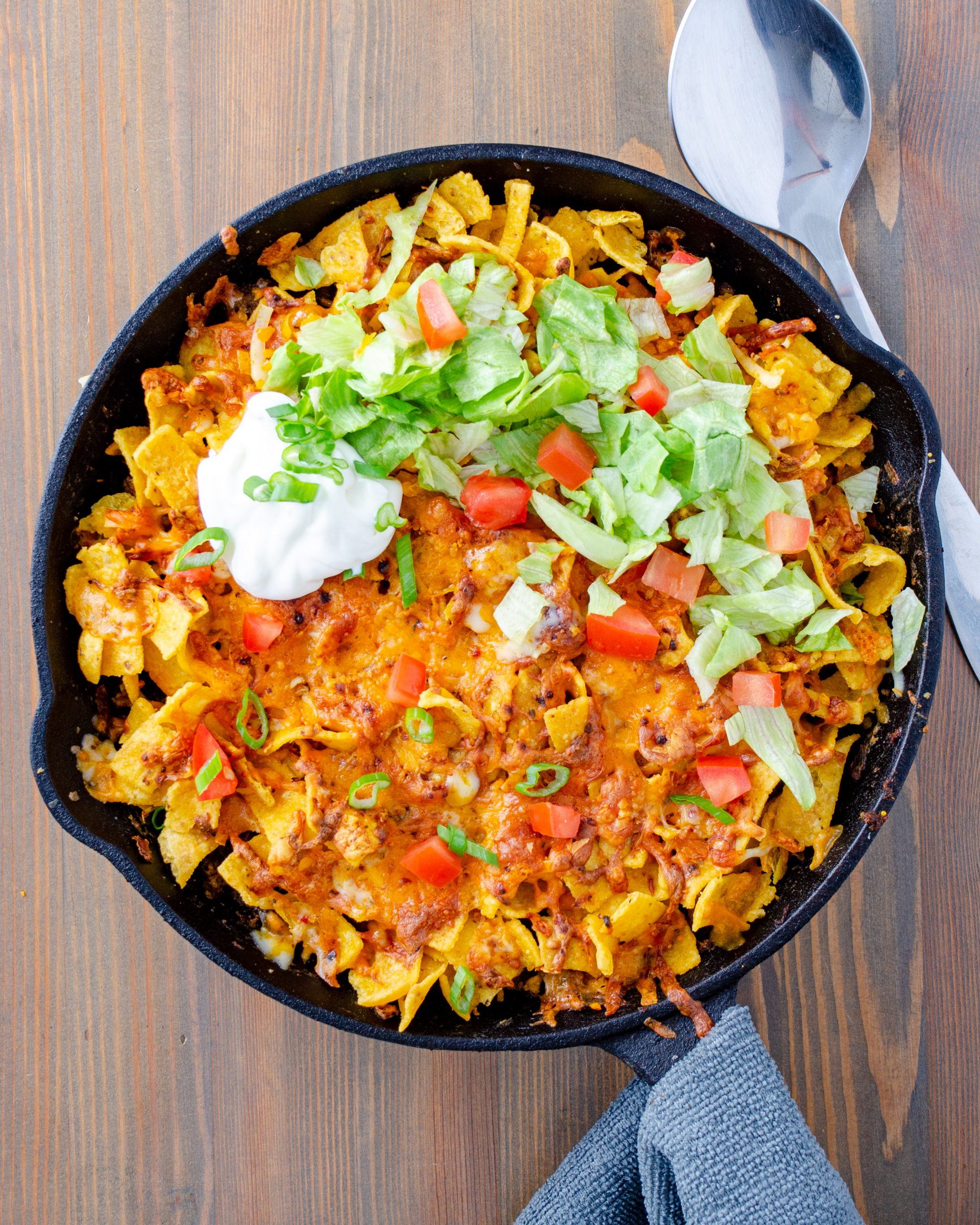 Remove the skillet from the oven and top with shredded lettuce and tomato.