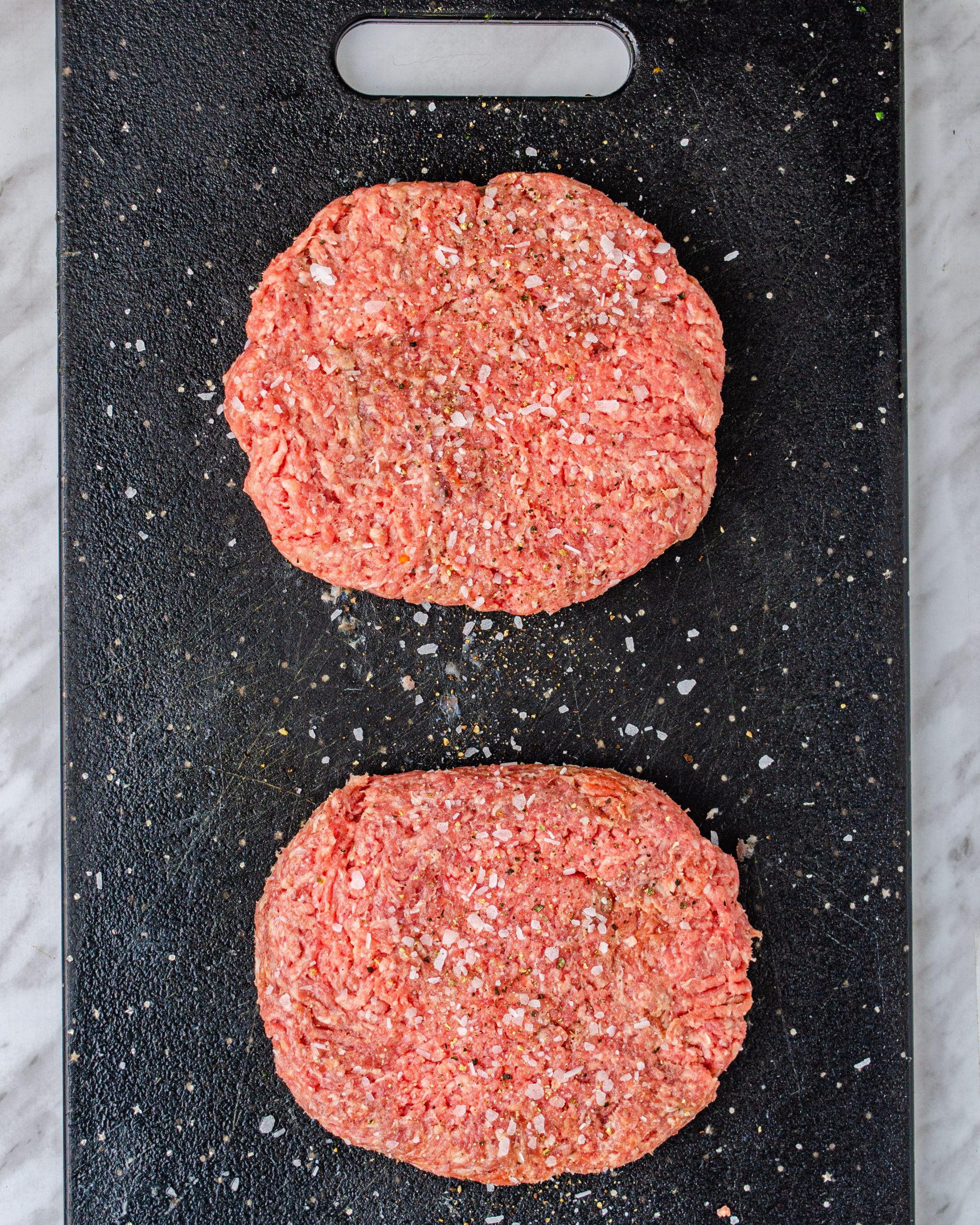 Form the ground beef into two separate patties and season with salt and pepper to taste.