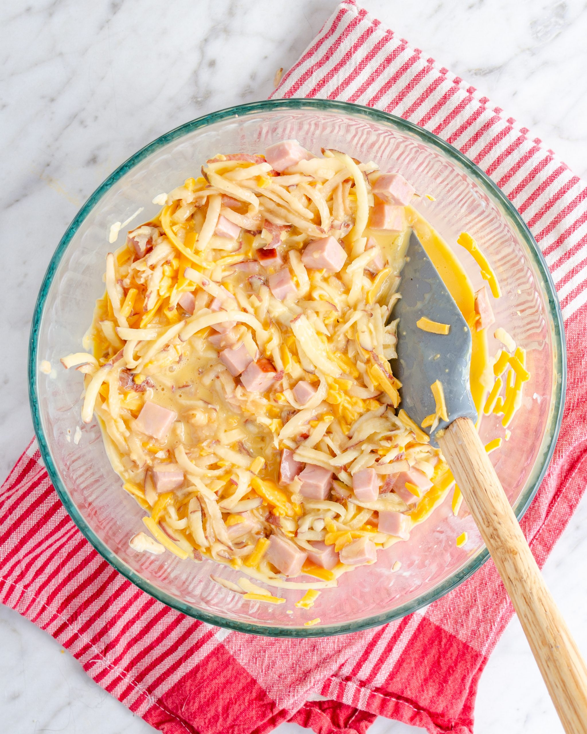 Stir in the potatoes, ham, and salt and pepper to taste.