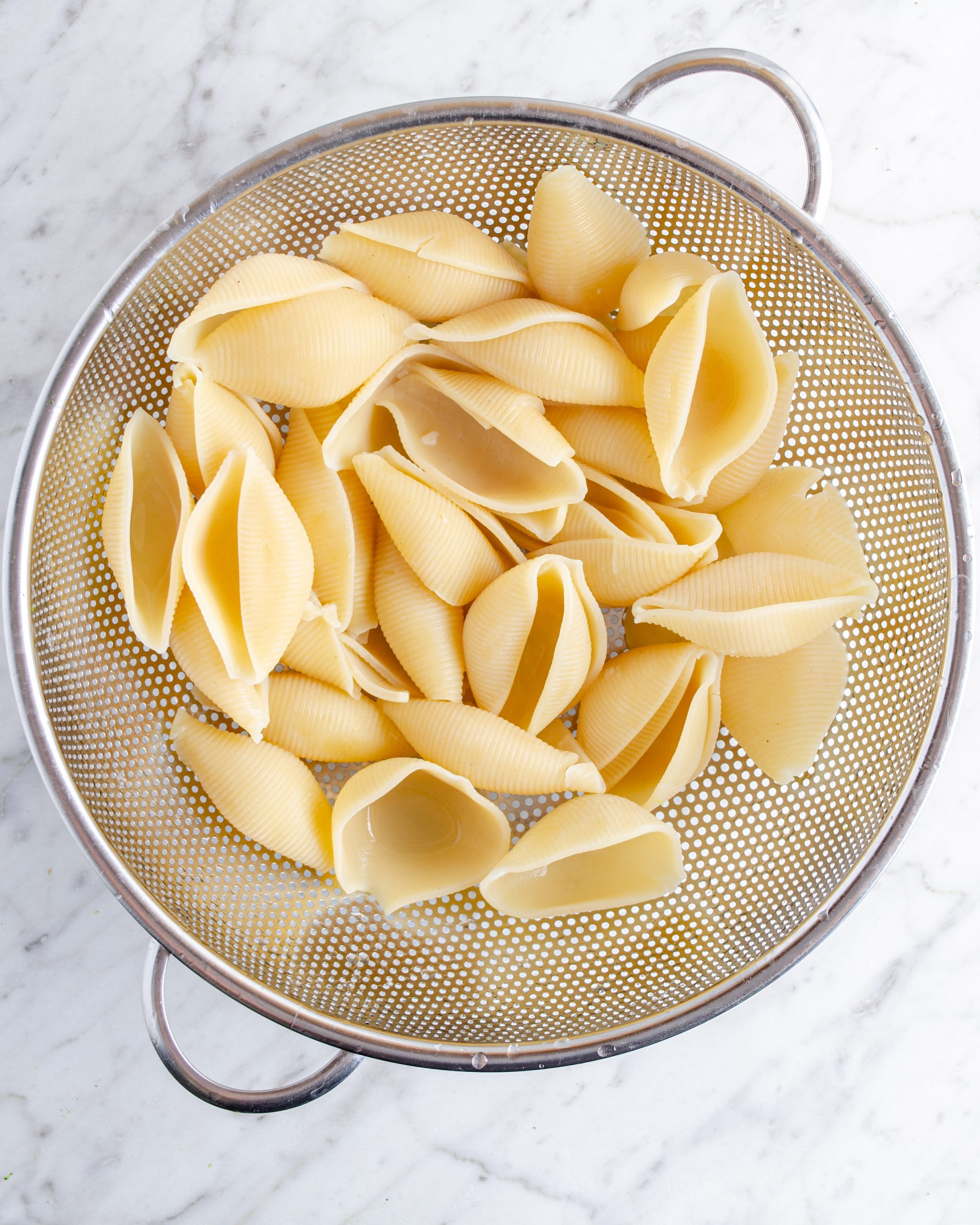 Boil the jumbo shells in water until al dente. Drain and rinse under cold water.
