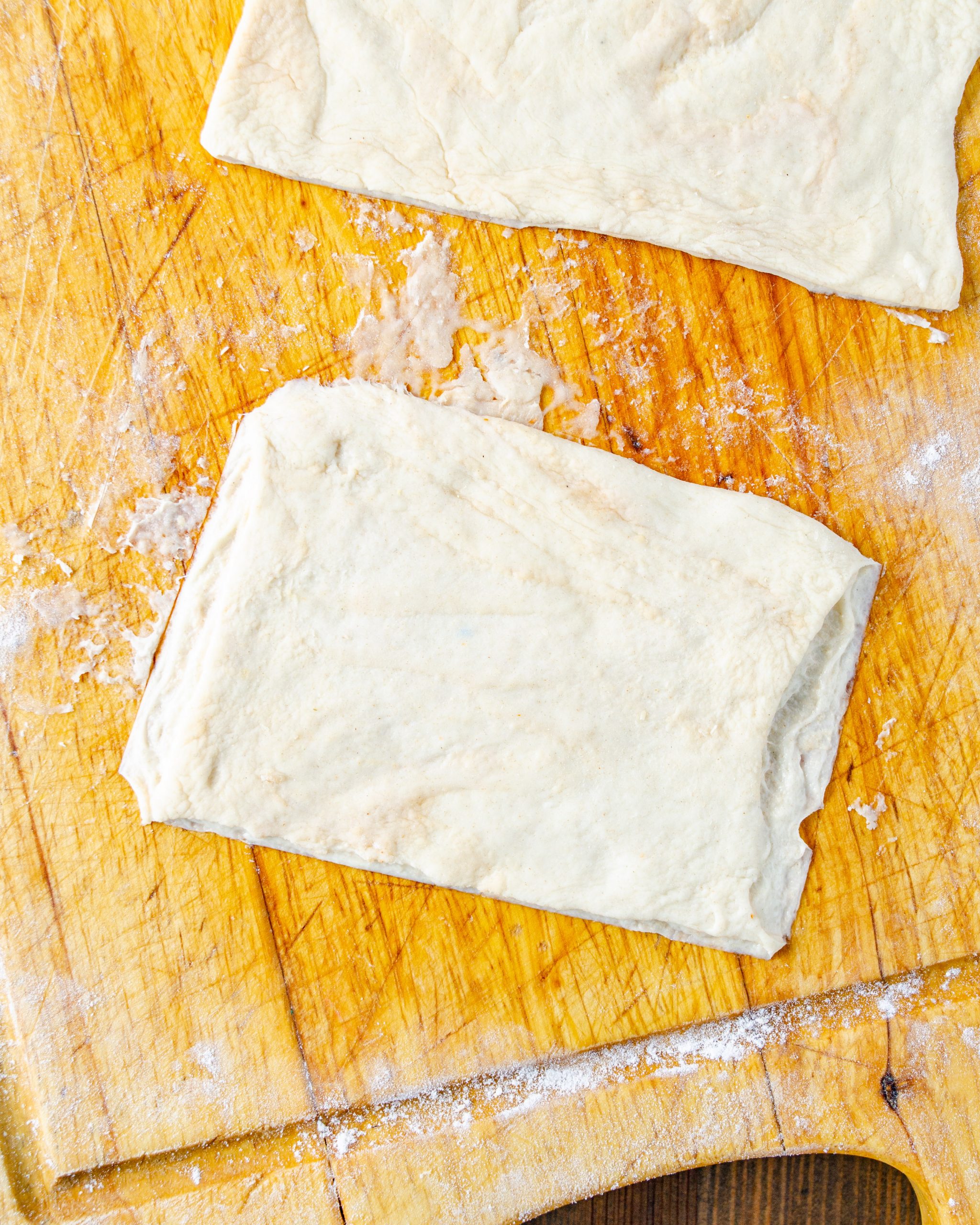 Cut the pizza crust into 4 even triangles.